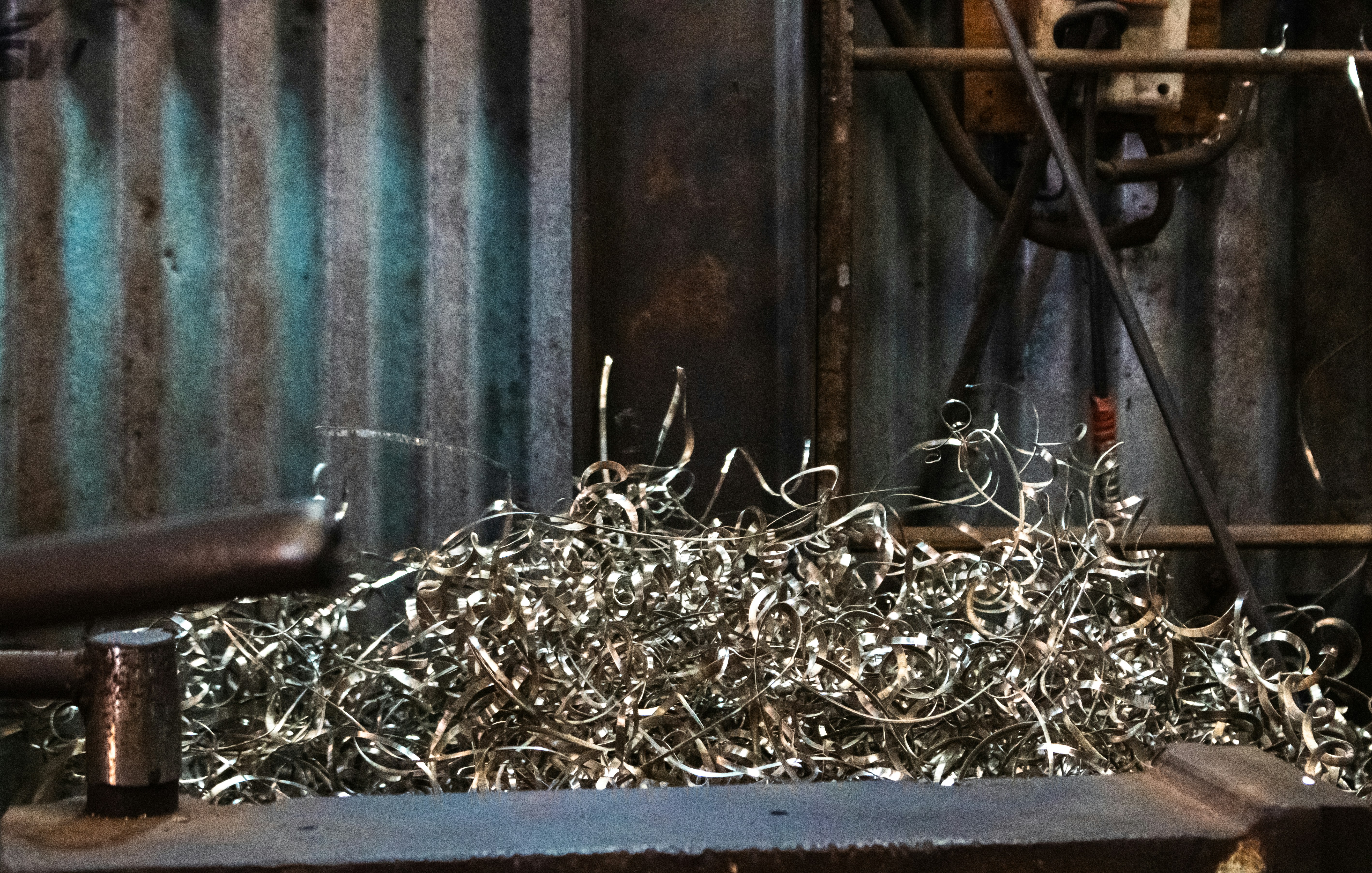 Metal shavings pile up on a workbench.