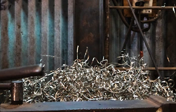 Metal shavings pile up on a workbench.