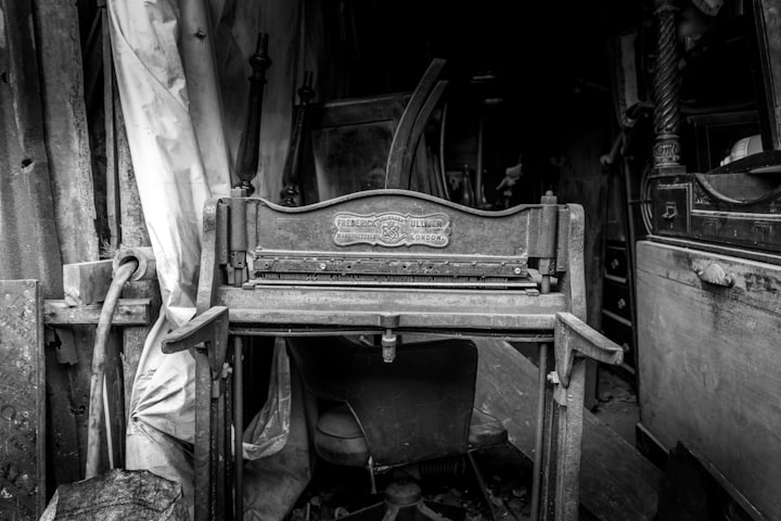 Antique cast-iron letterpress platen press standing in a working print shop