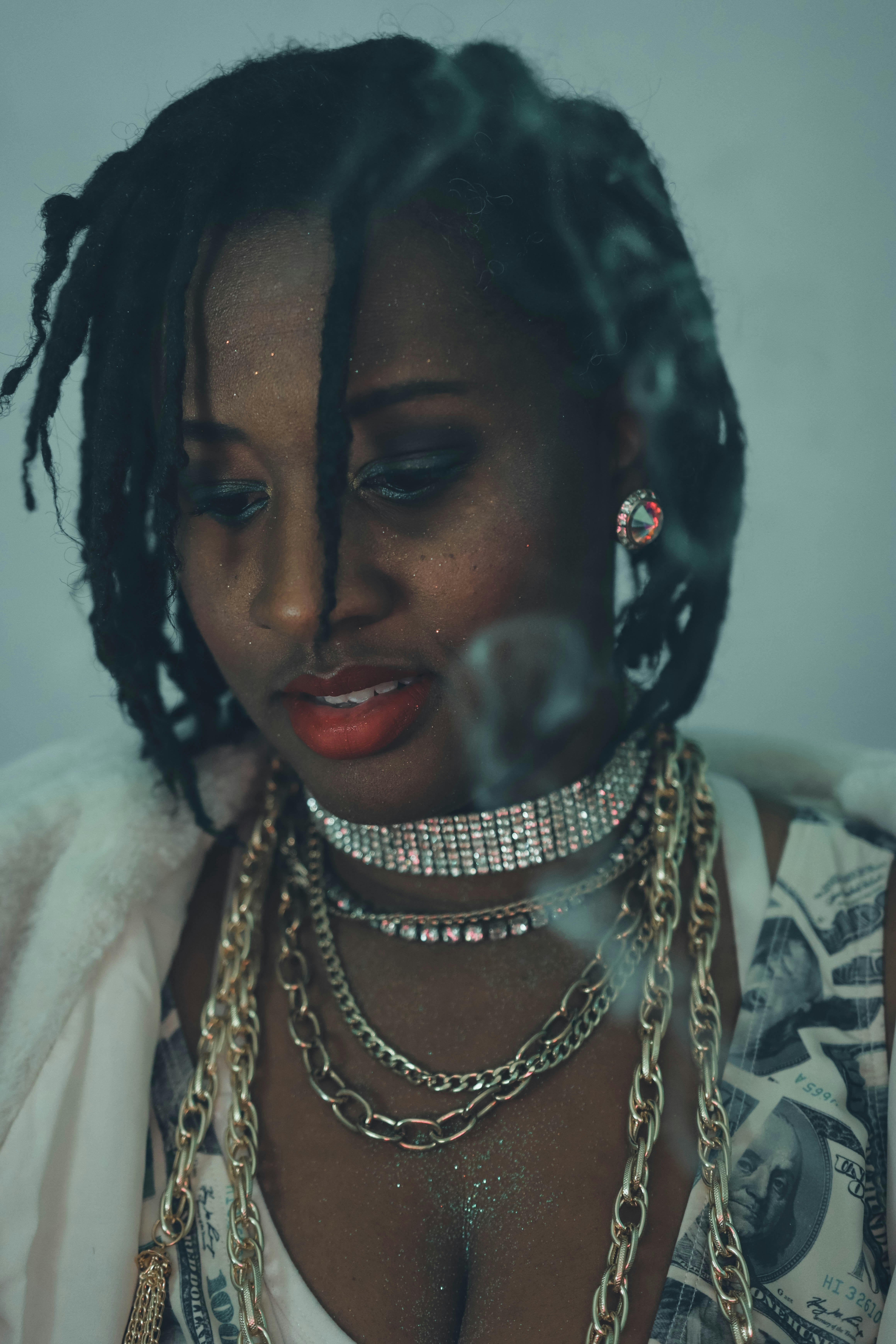 Woman with dreadlocks and layered necklaces