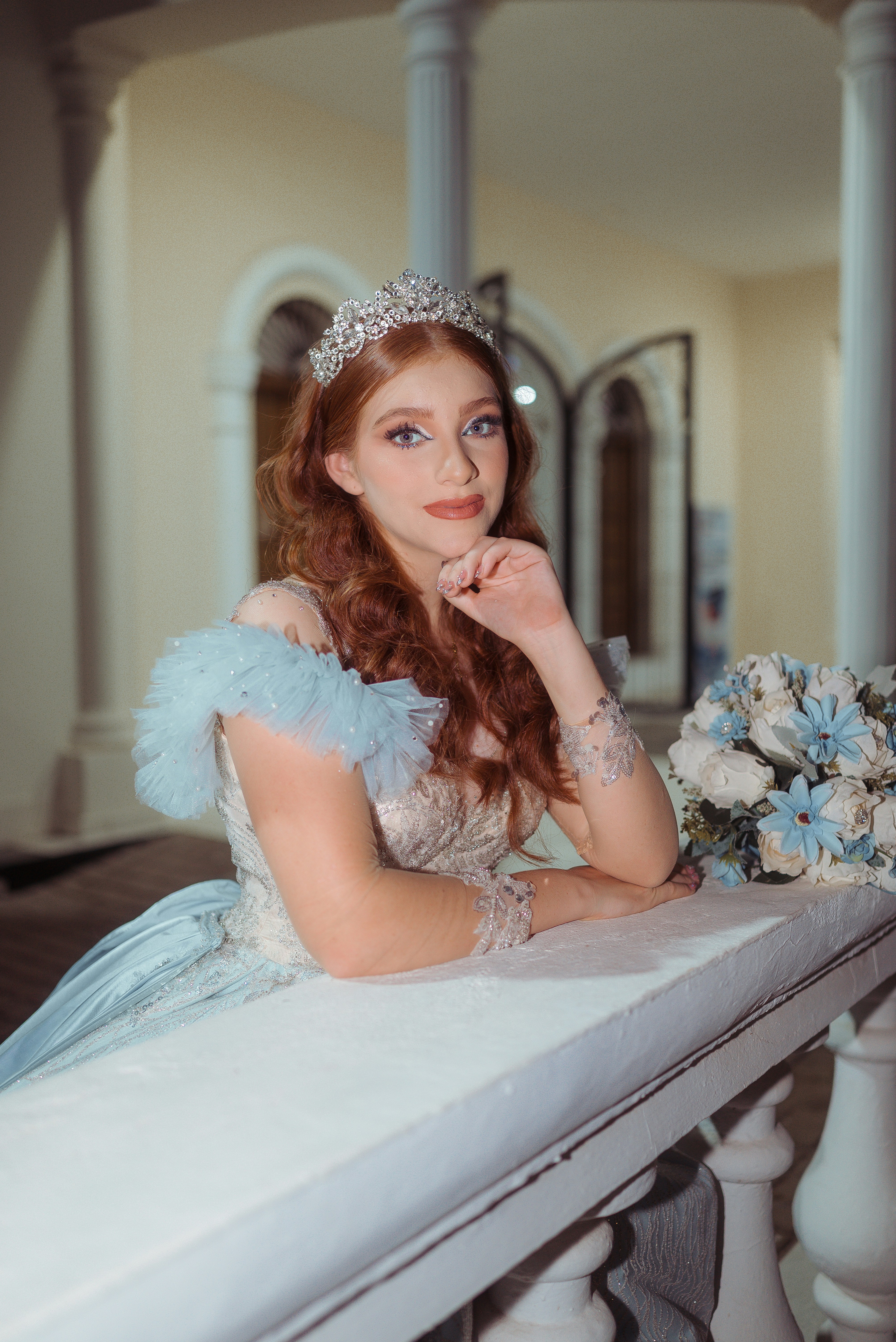 Young woman in a tiara and blue gown