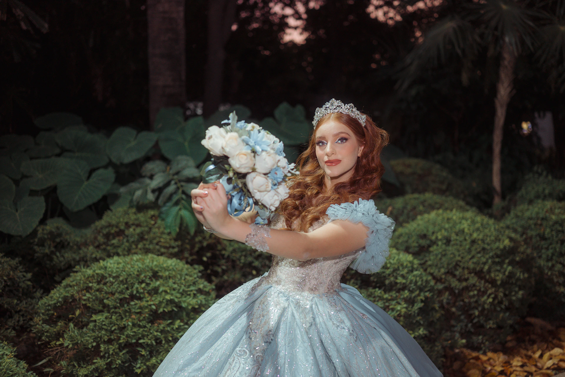 Woman in a blue gown holding a bouquet