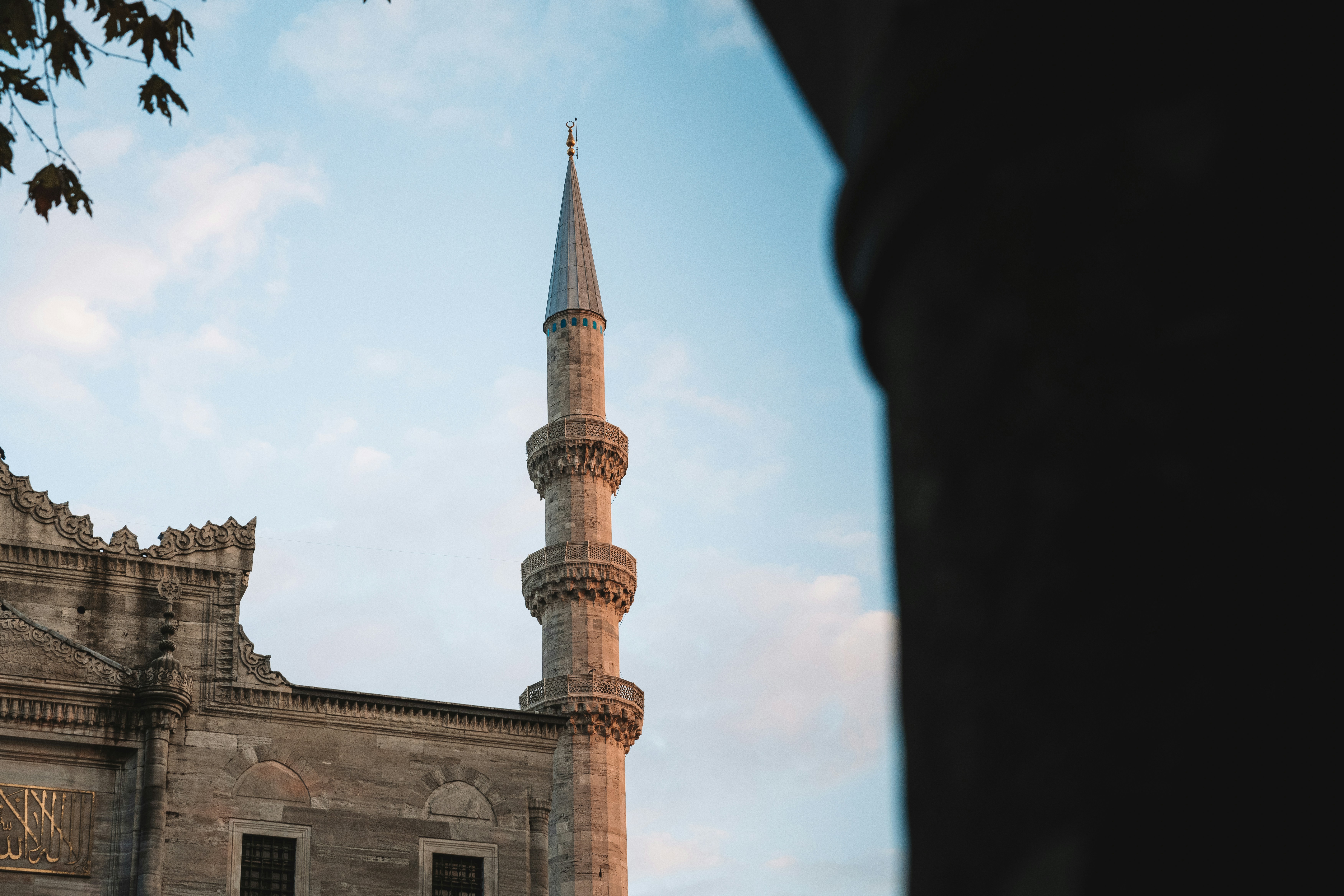 Minaret of a mosque against a blue sky