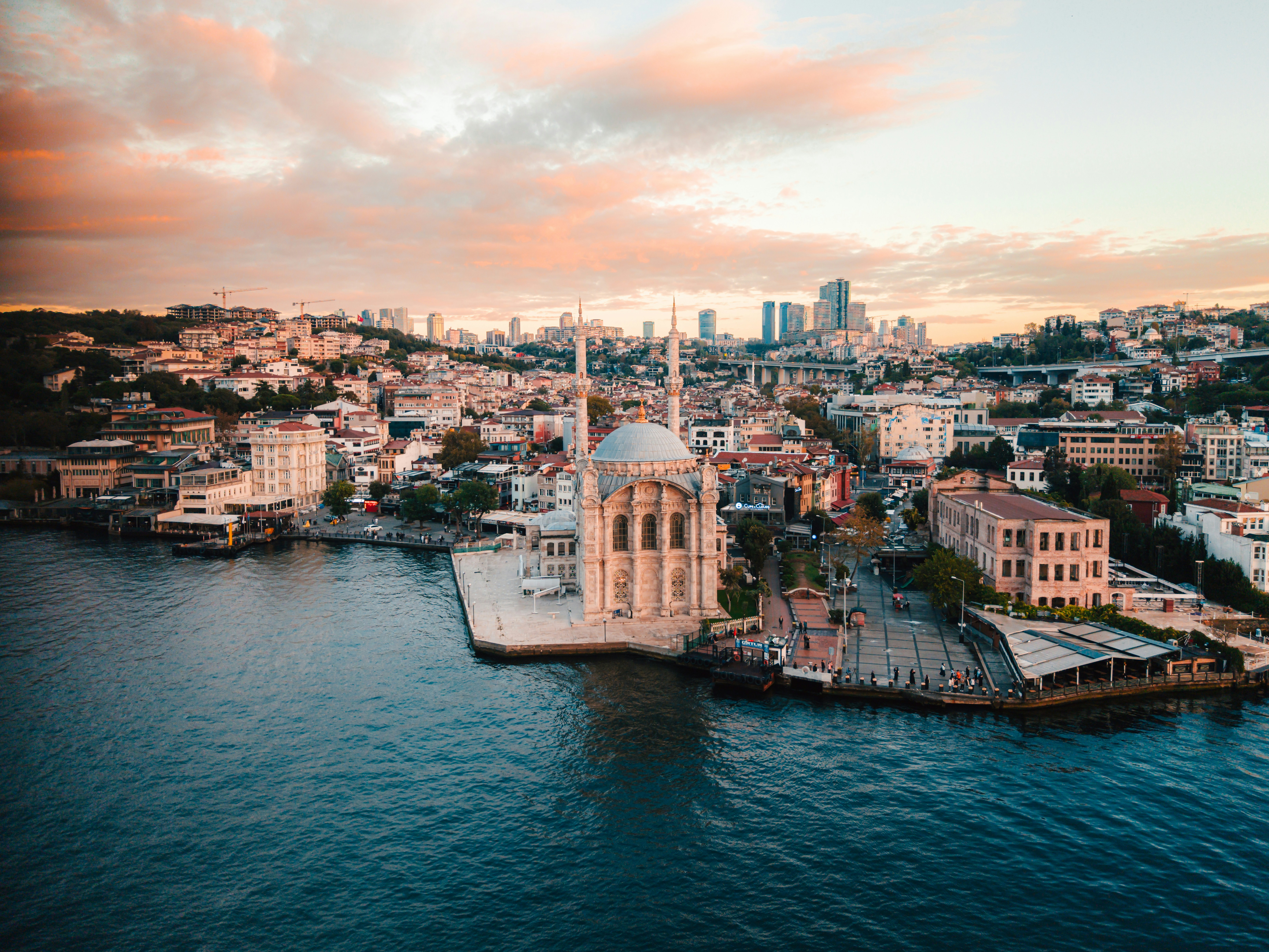 Mosque and cityscape on the water at sunset