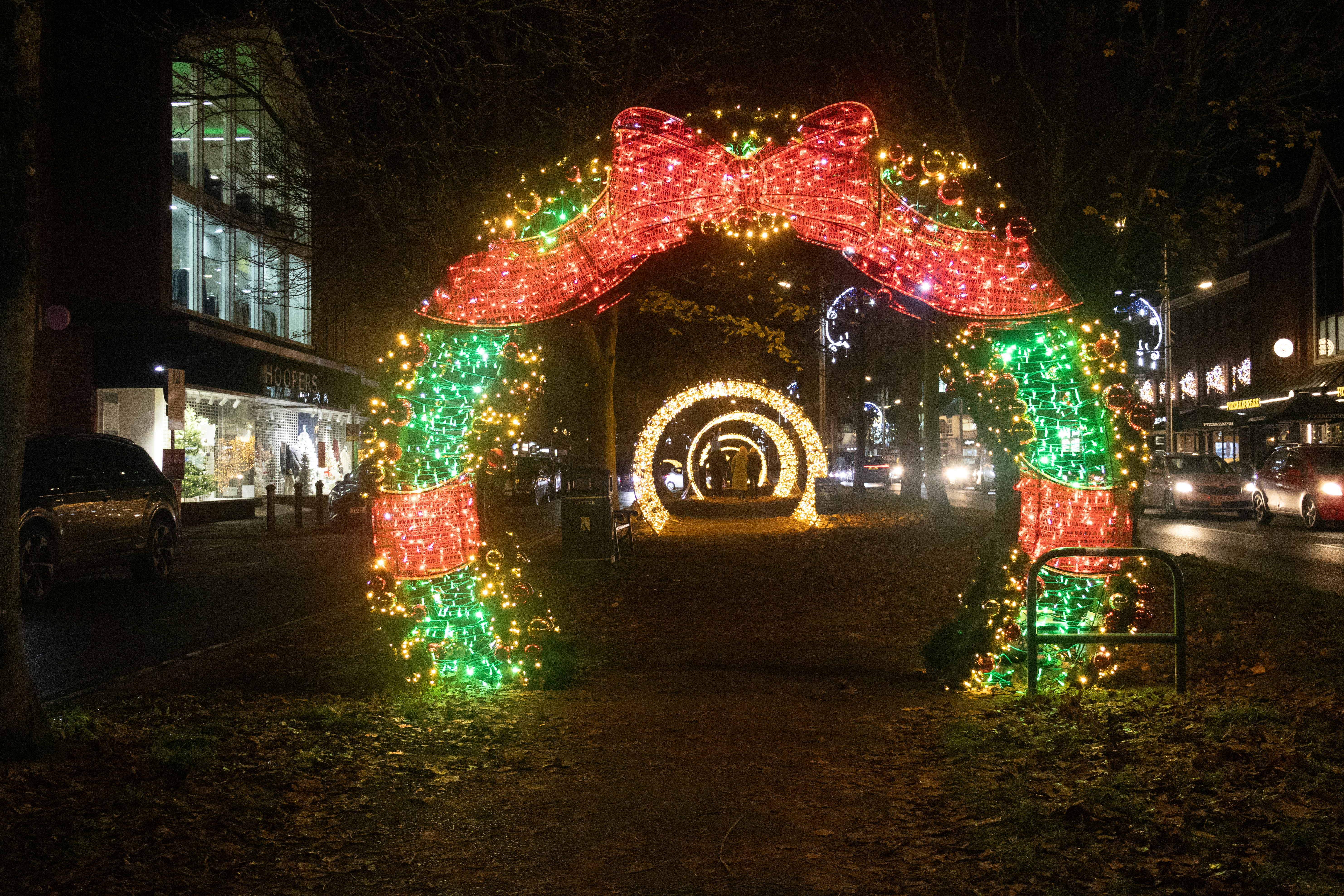 Christmas lights archway on a street at night