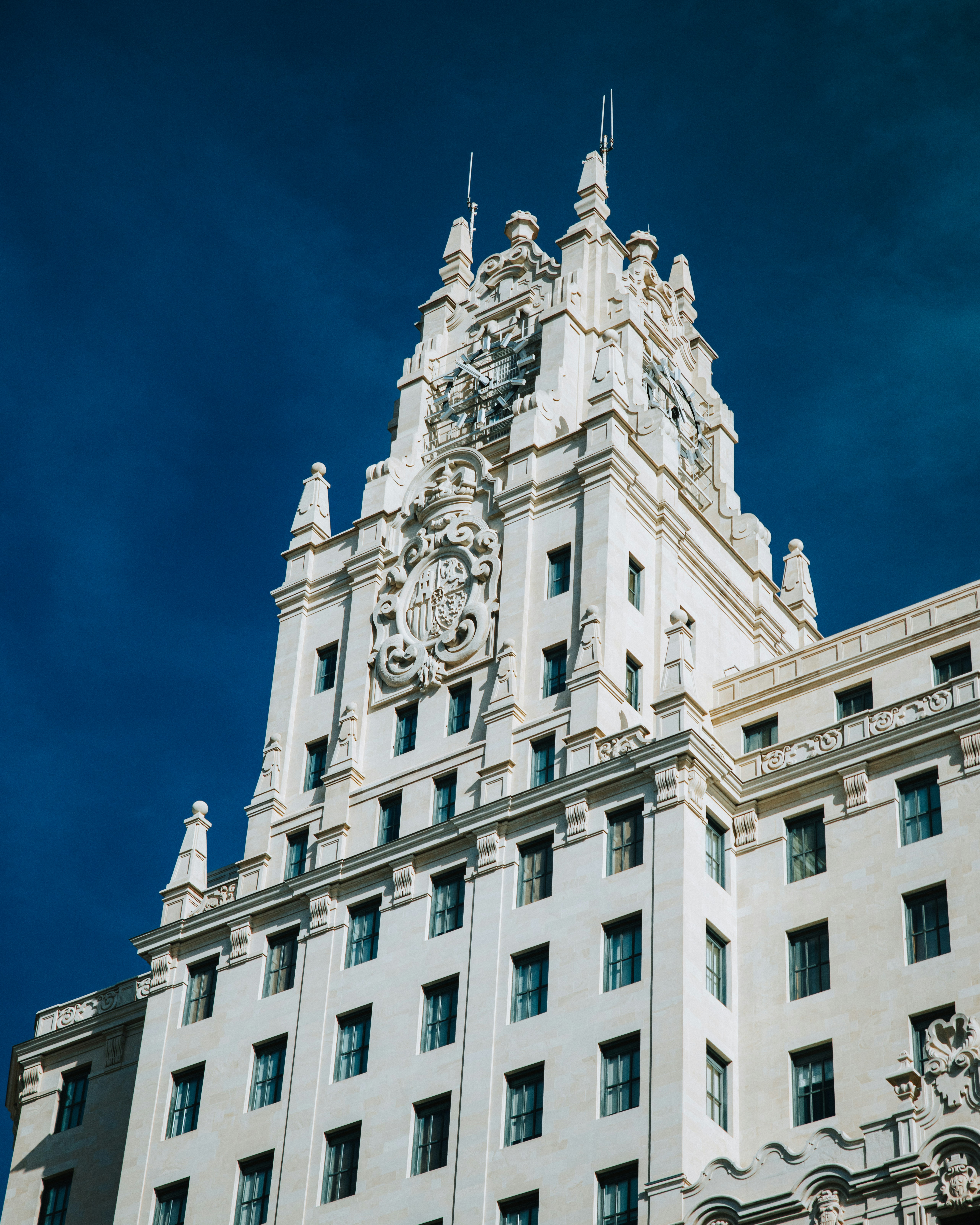 Ornate white building facade against a deep blue sky
