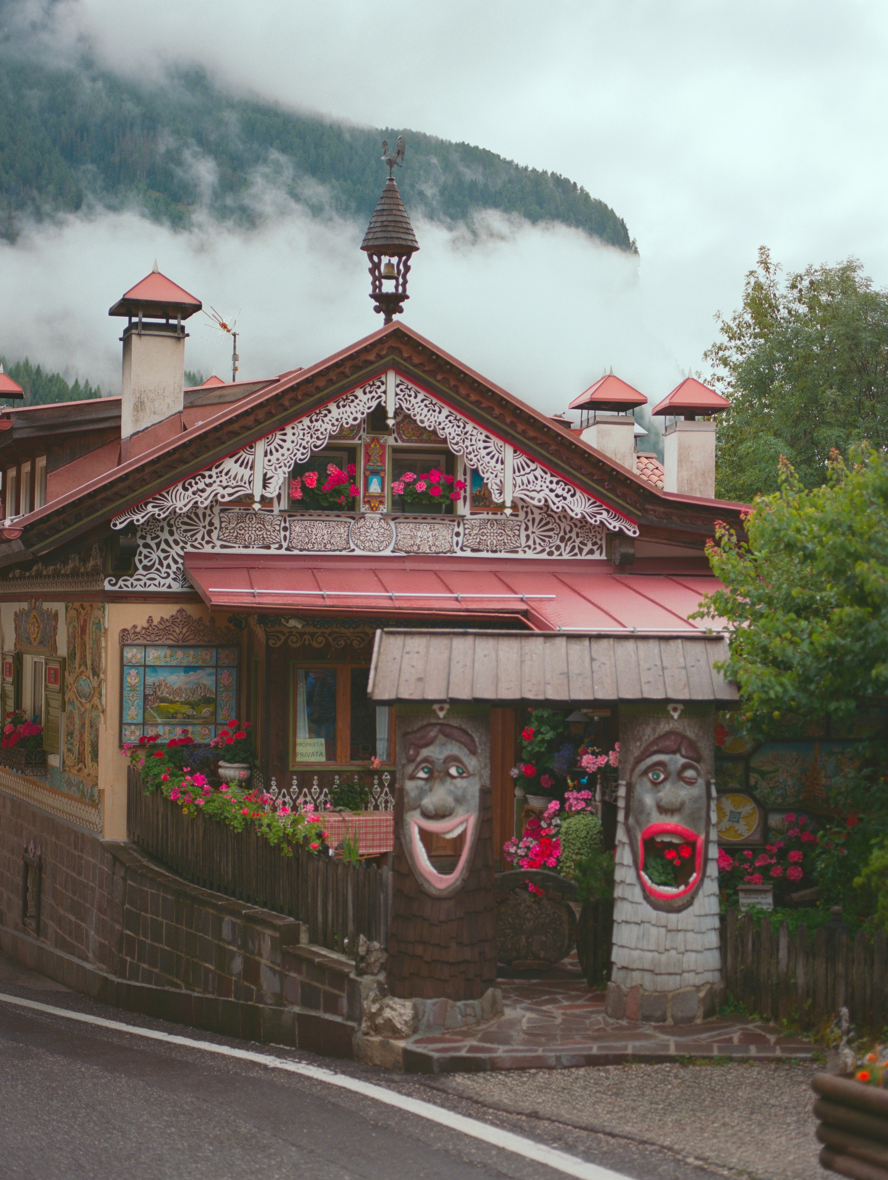 Ornate house with carved faces and flowers
