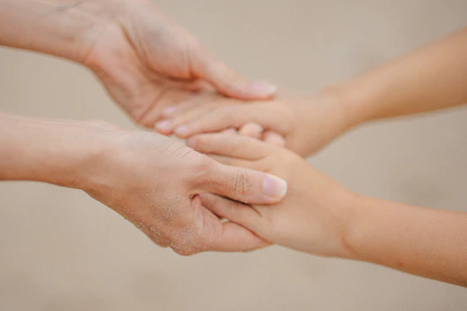 Two hands gently holding each other
