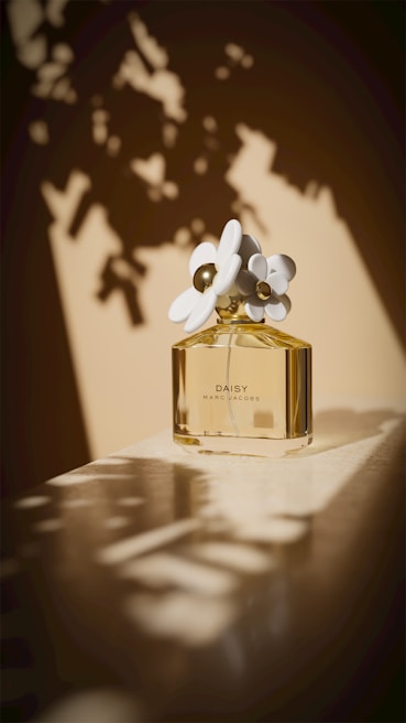 A bottle of daisy perfume with floral accents.