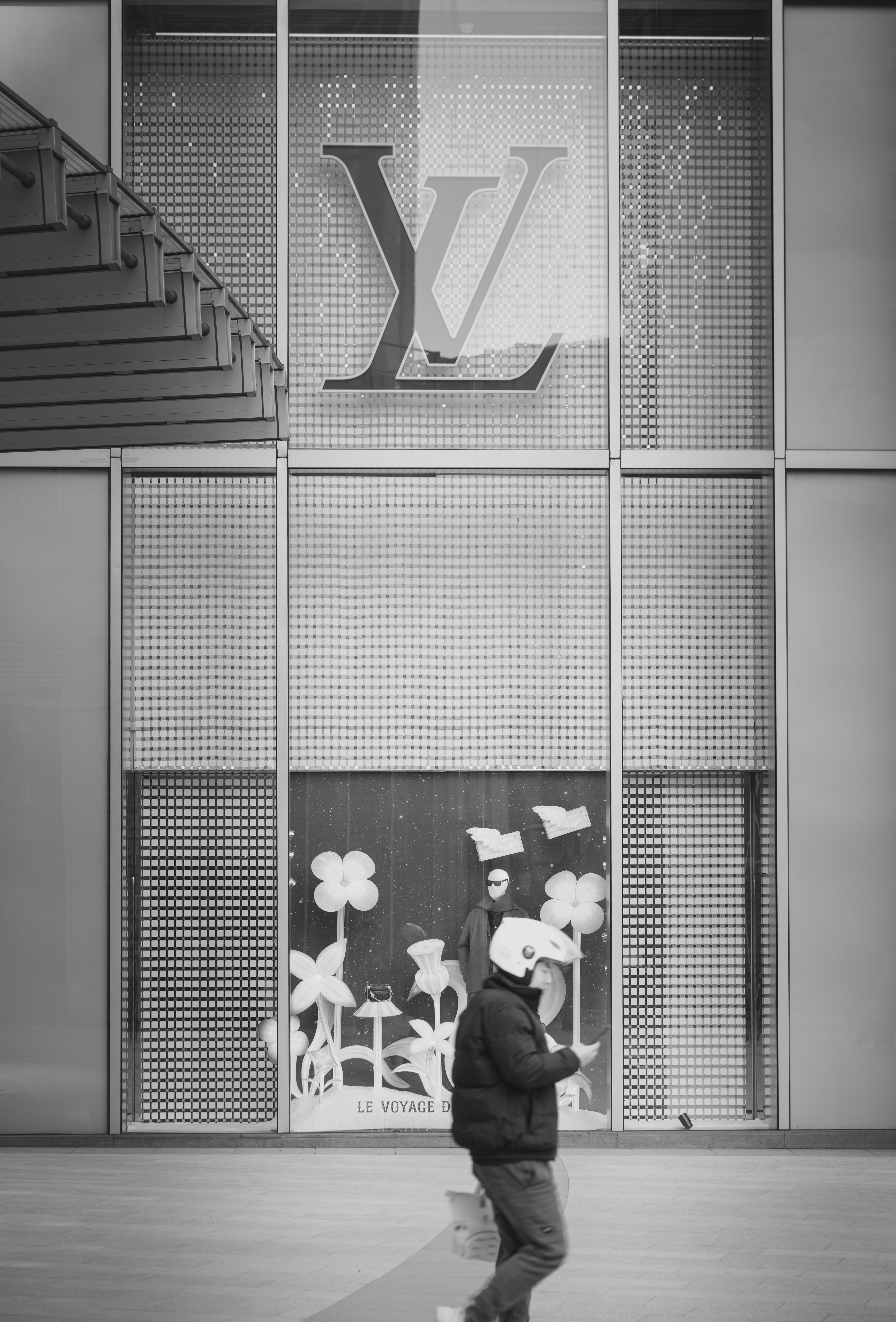 Un homme passe devant la vitrine du magasin Louis Vuitton