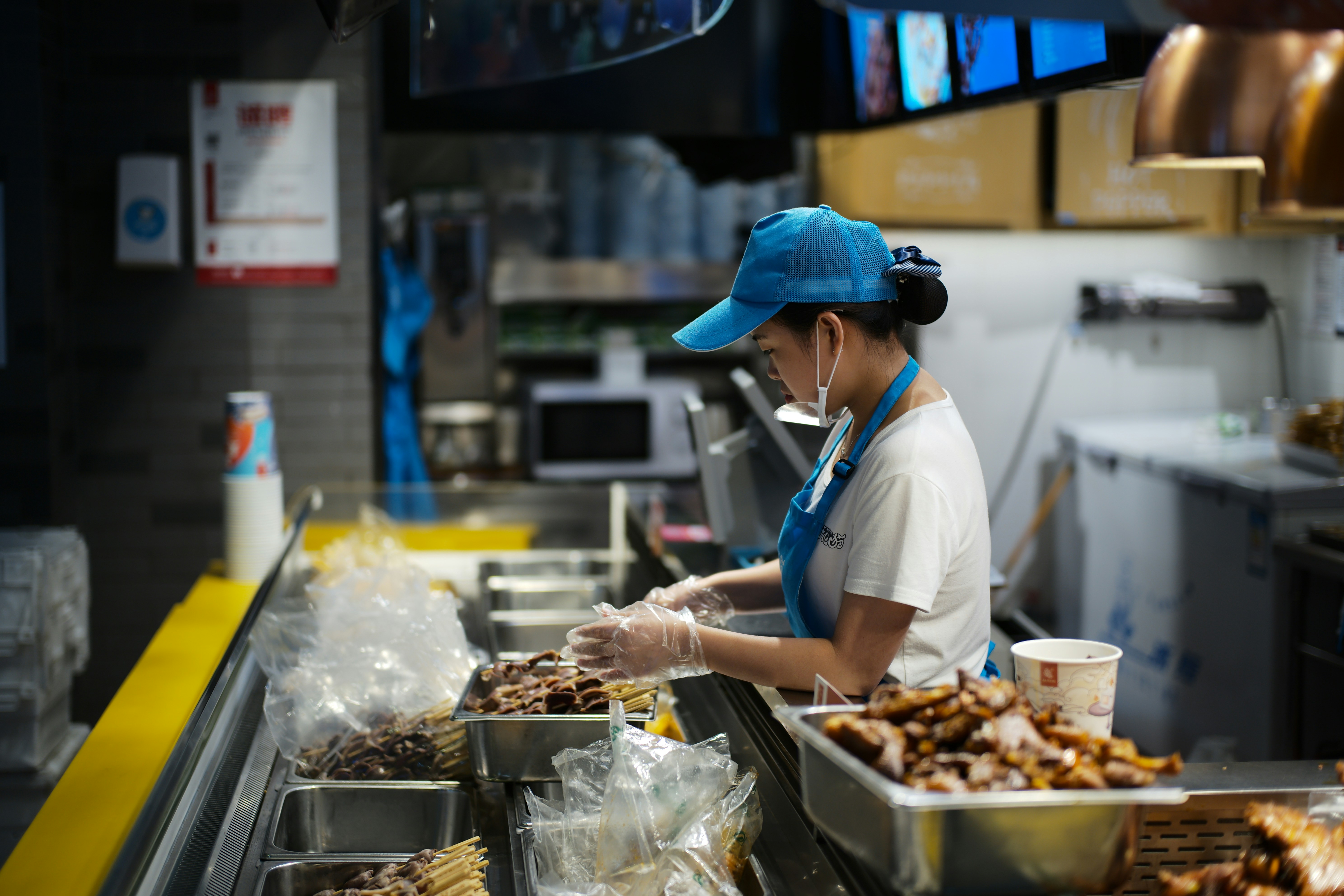 A person working behind a food counter