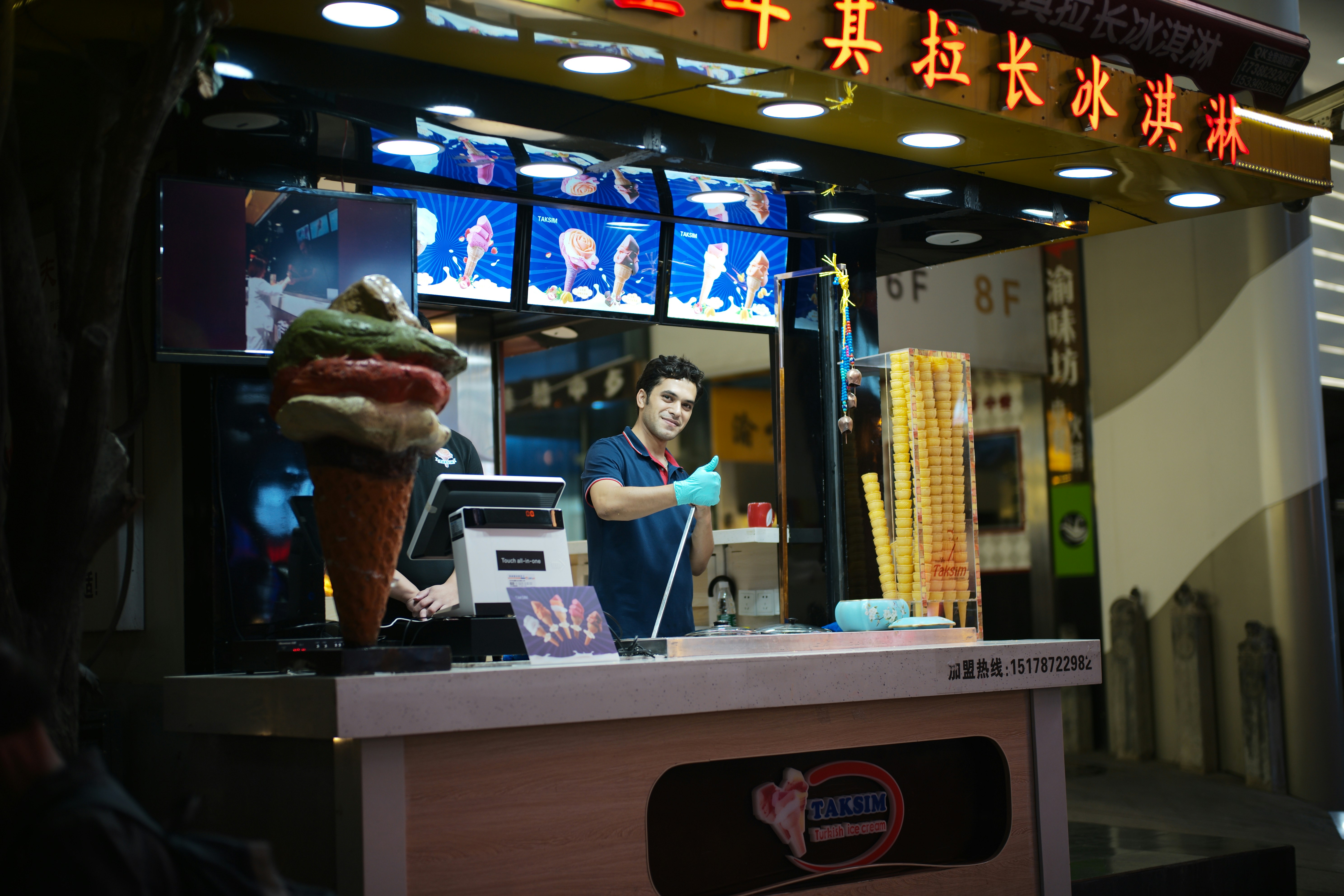 Man preparing ice cream at a street stall.
