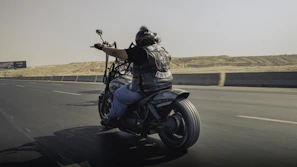 Man riding a motorcycle on a desert highway