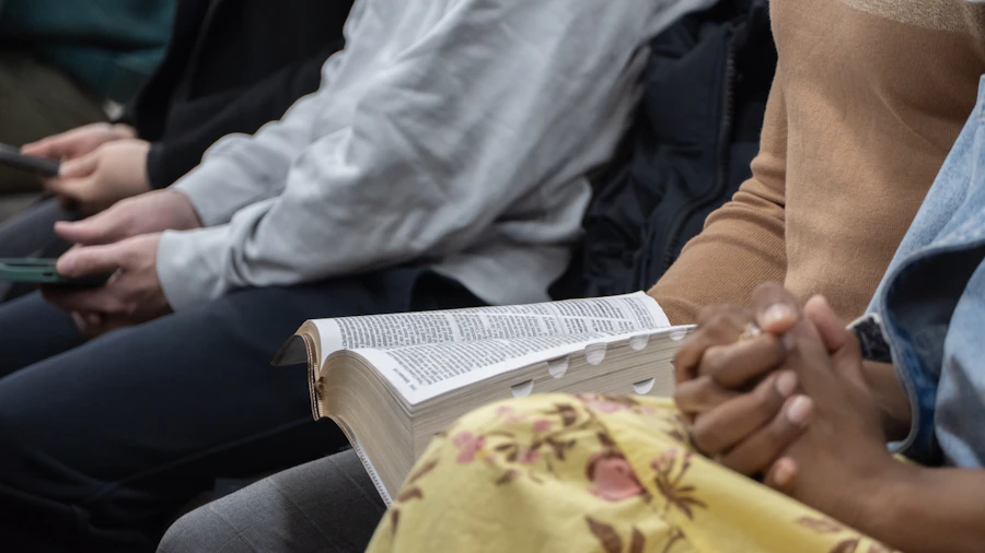 People seated with an open Bible during a small group gathering