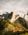 Ancient inca citadel of machu picchu shrouded in mist.