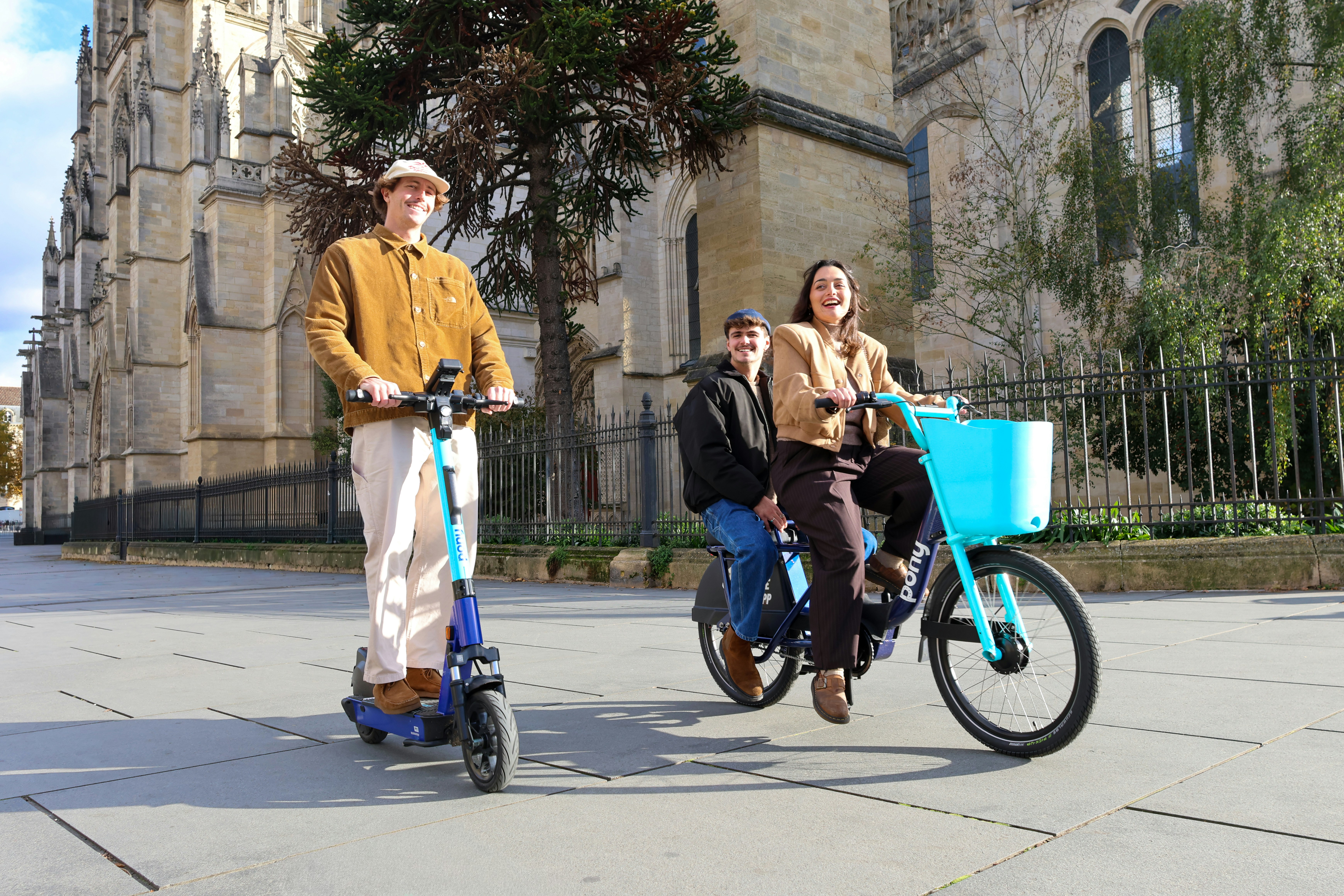 People riding electric scooter and bicycle outdoors