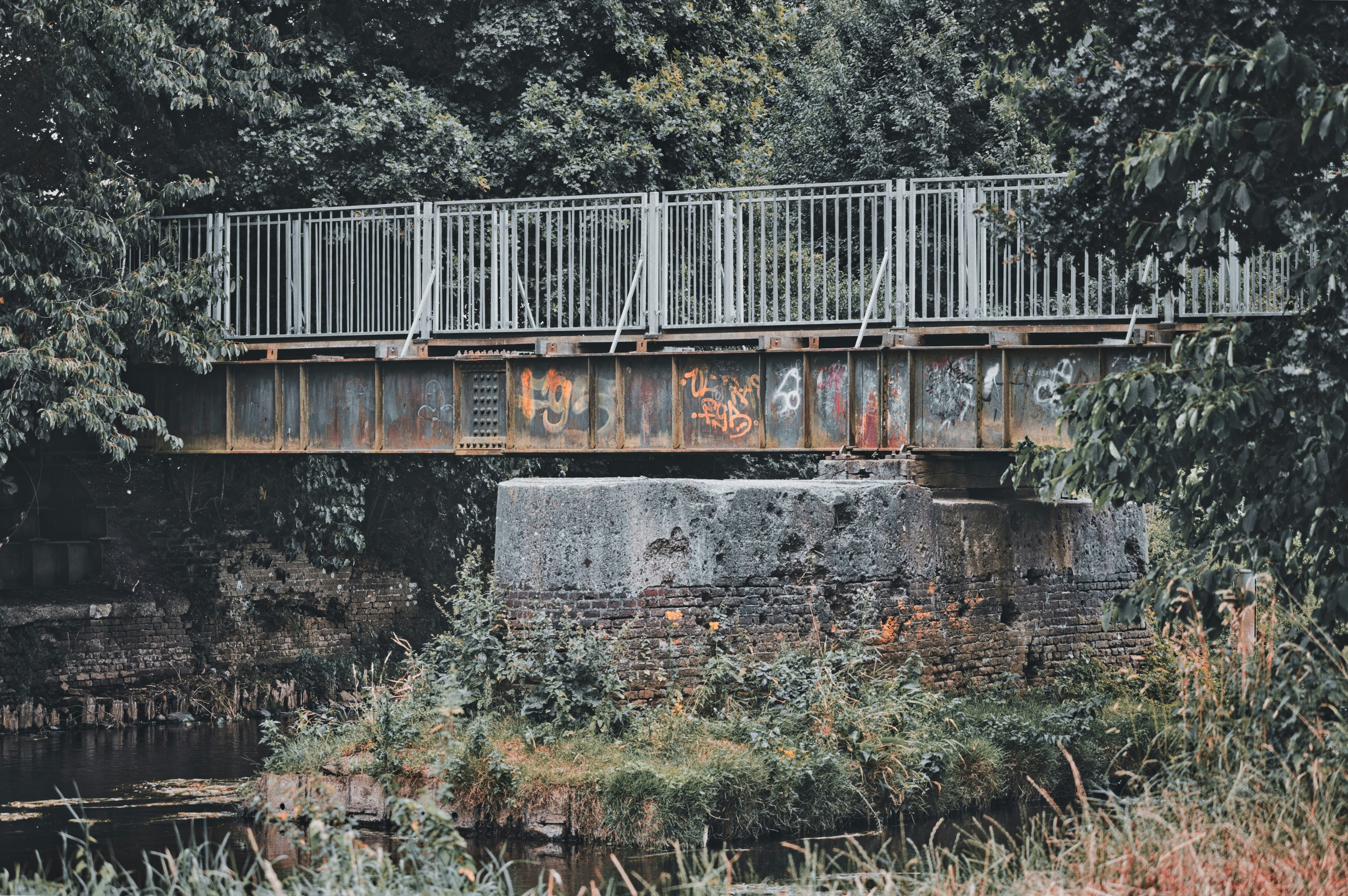 A weathered metal bridge over a body of water