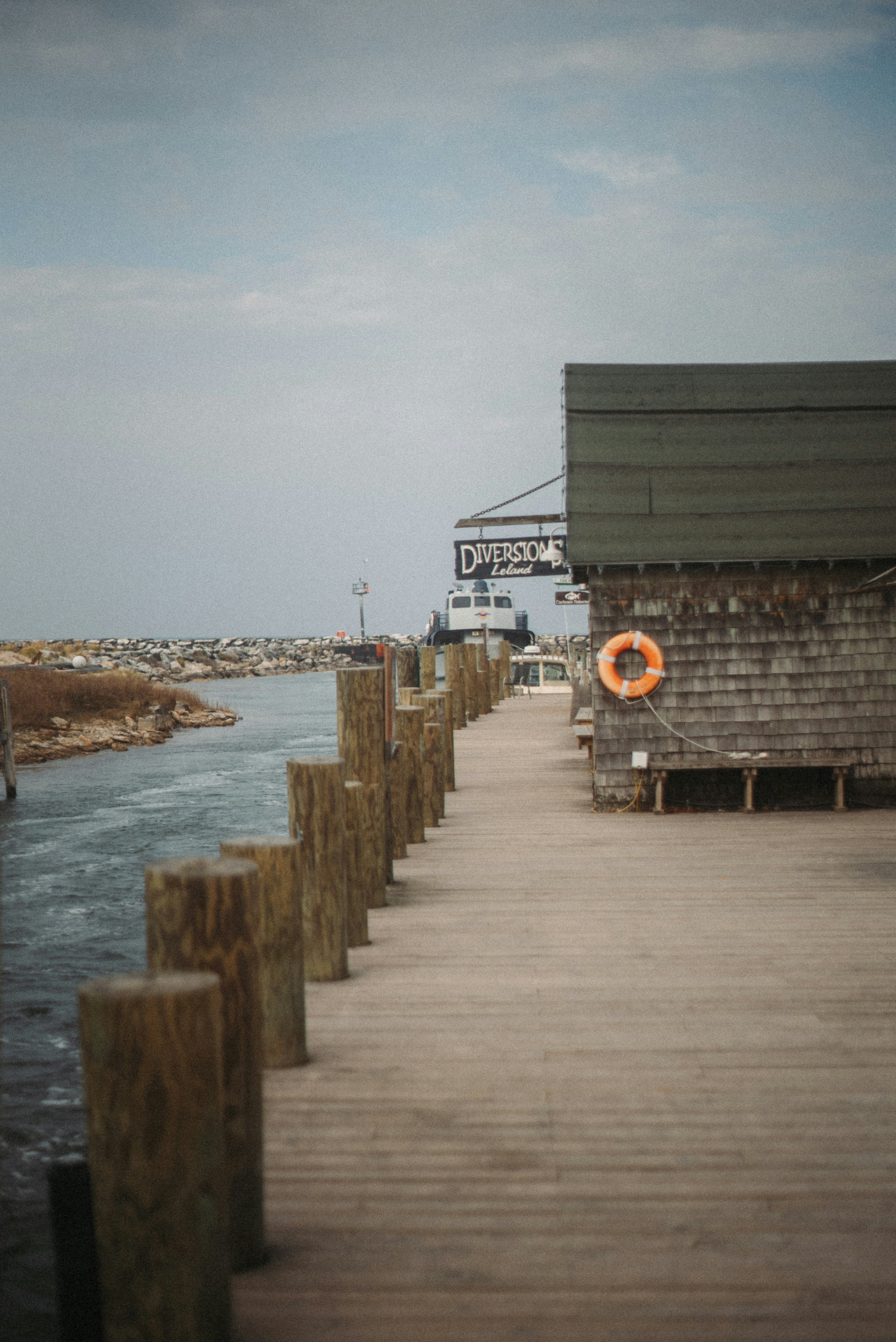 Wooden pier with weathered buildings and boats