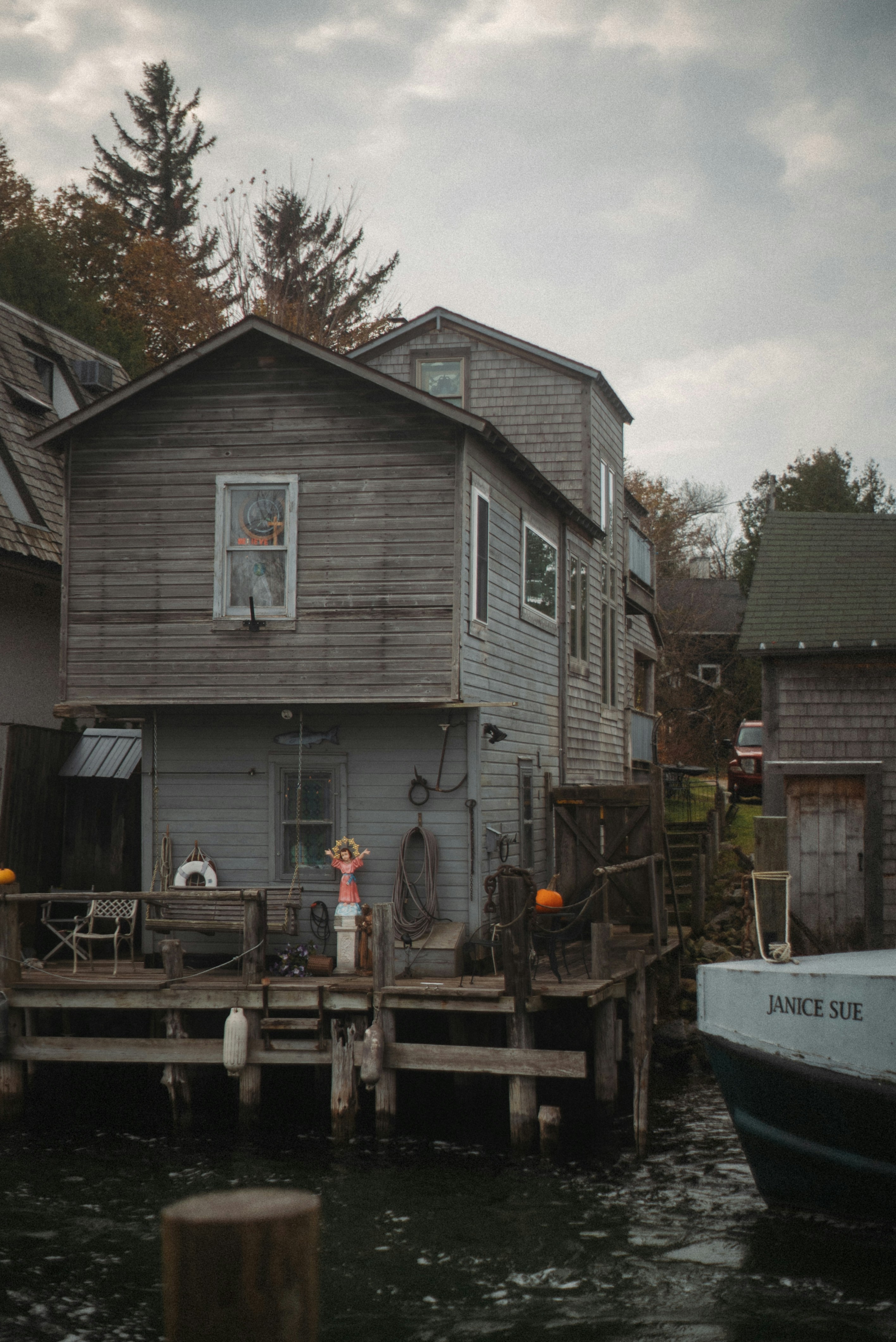 Weathered wooden buildings on a waterfront pier.