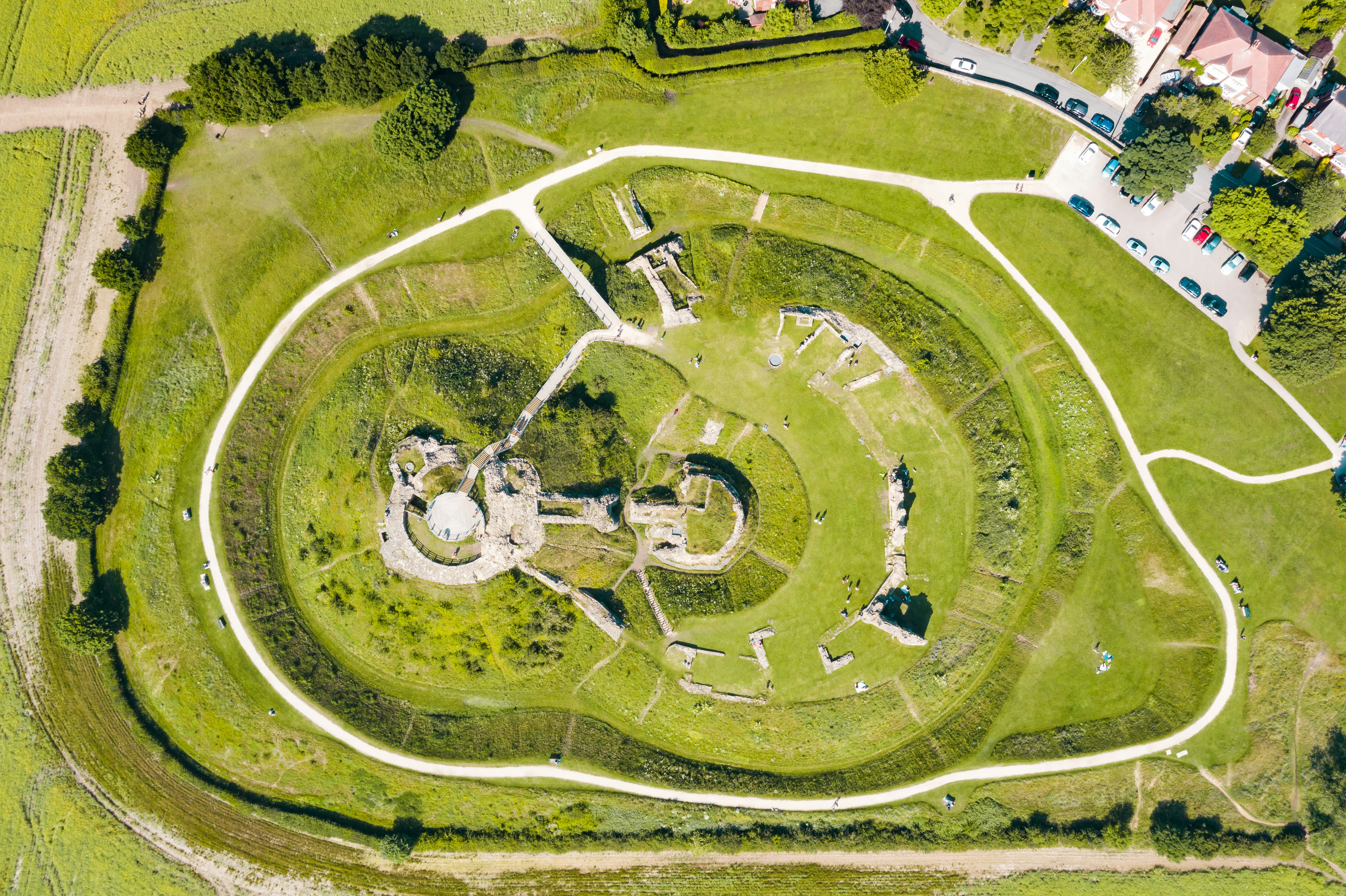 Aerial view of ancient circular earthworks and ruins
