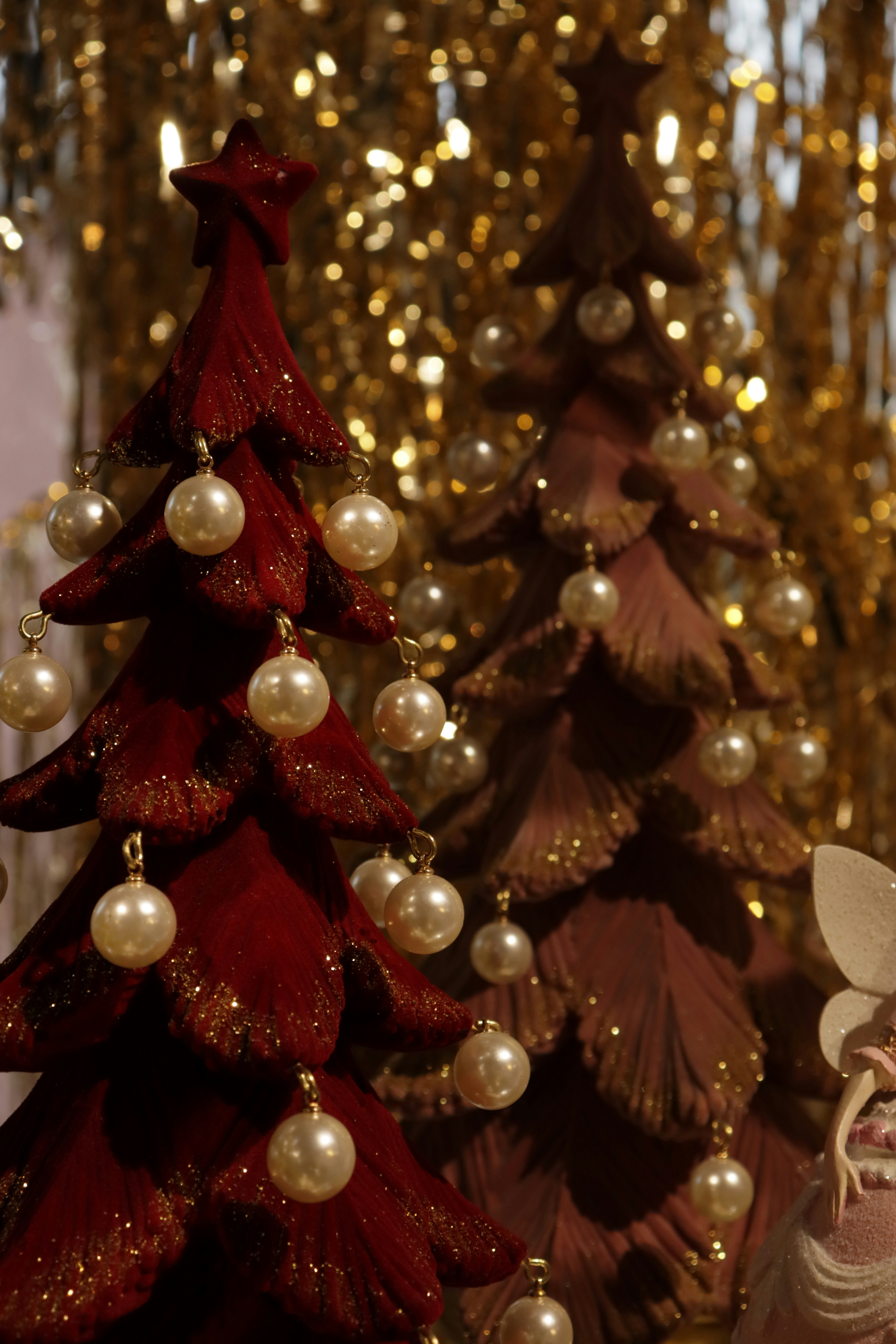 Two decorative christmas trees with pearl ornaments