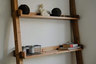 Wooden ladder shelf with decorative items and books.