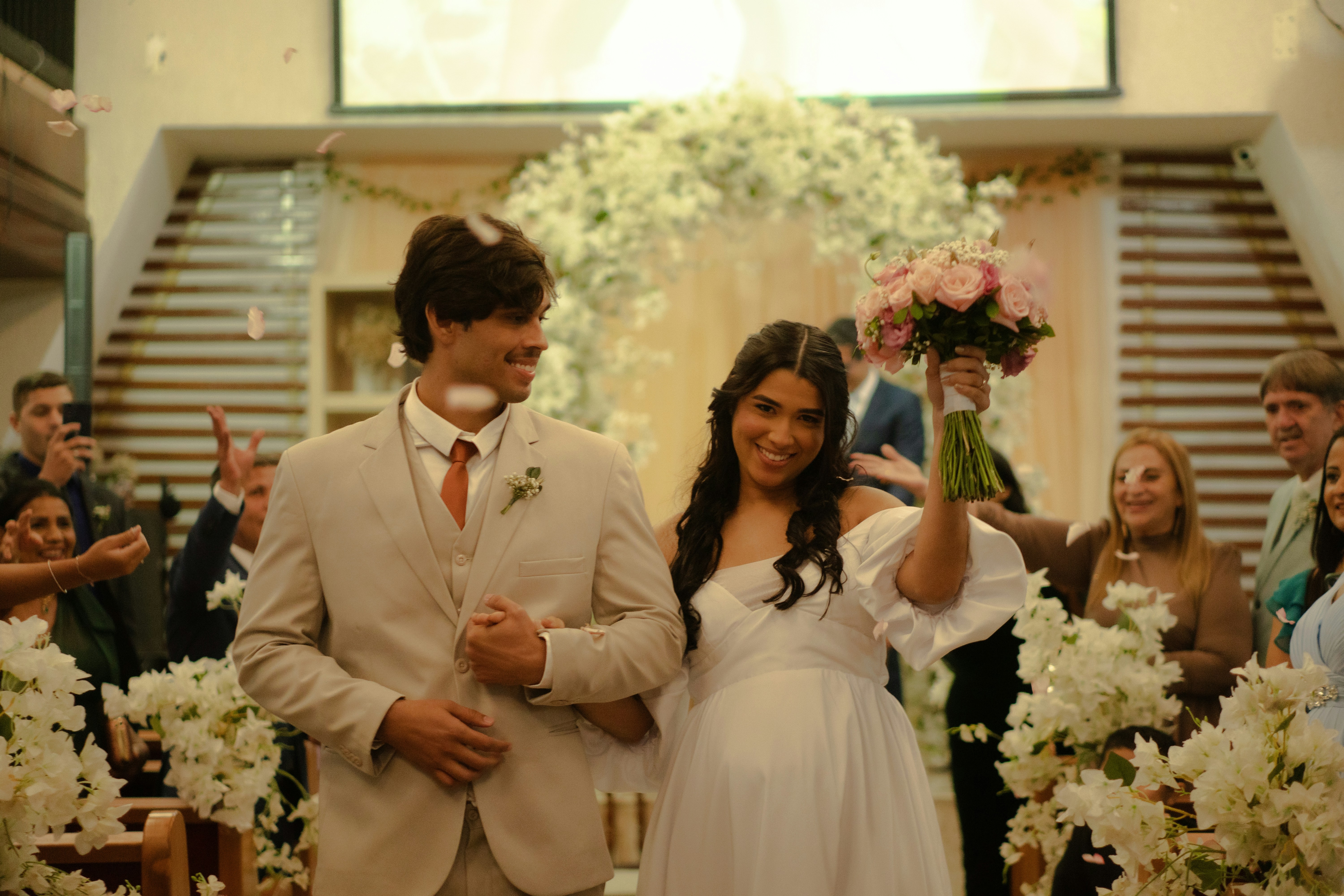 Newlyweds walk down aisle with confetti falling