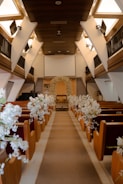 Wedding aisle decorated with white flowers and arch