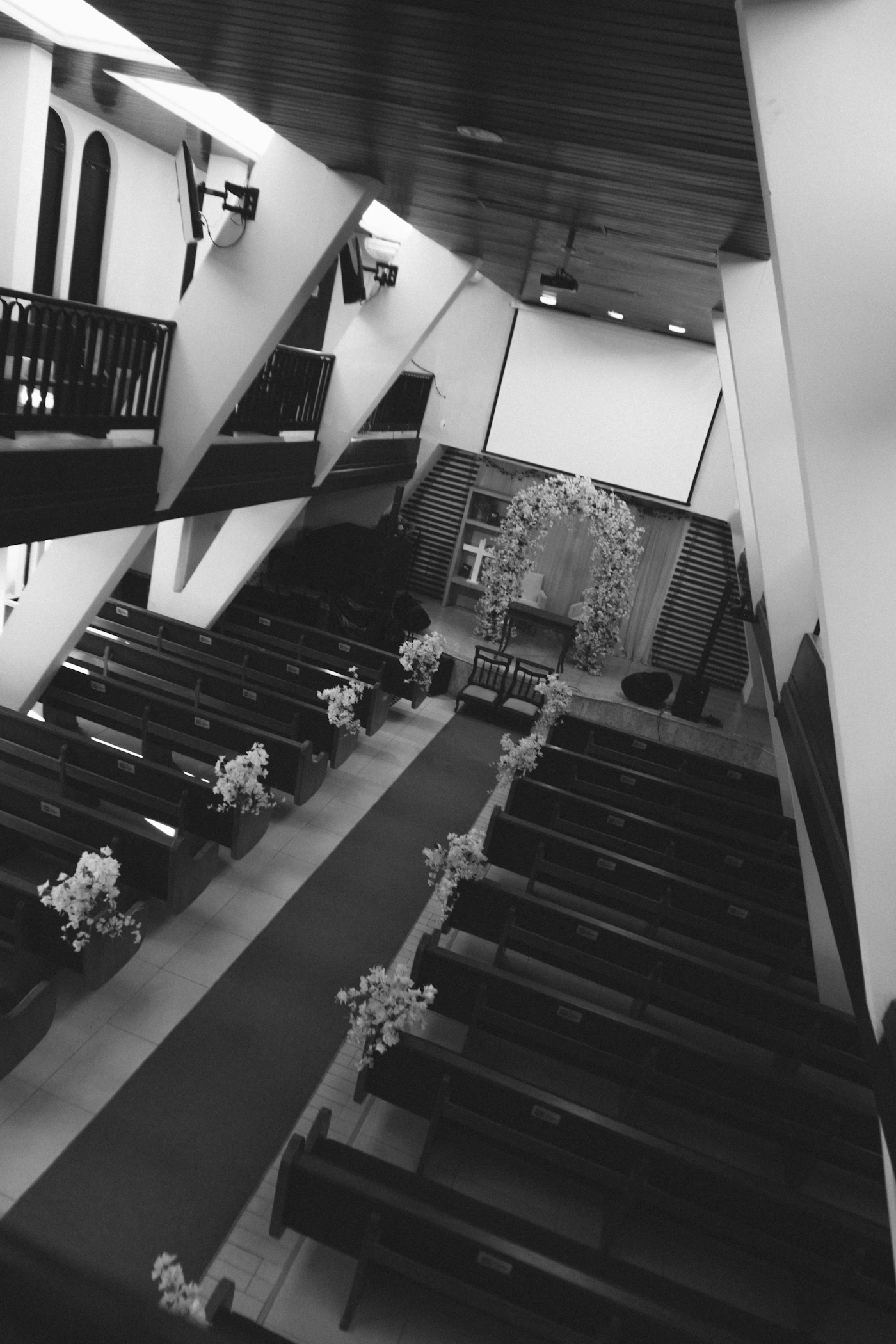 Wedding altar decorated with flowers inside a church showing the formal ceremony space that most churches require photographers to document from restricted positions