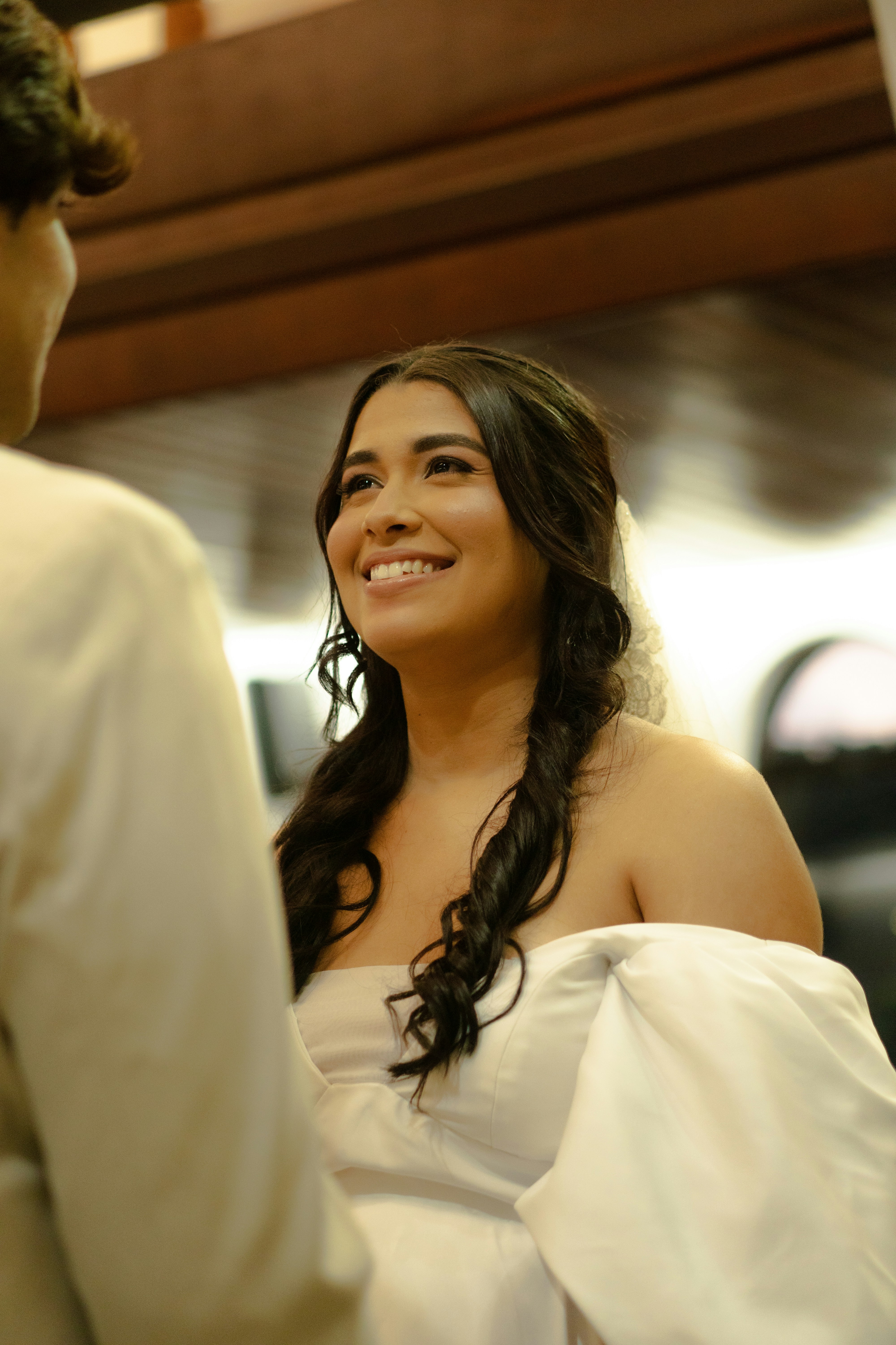 A smiling bride in a white wedding dress