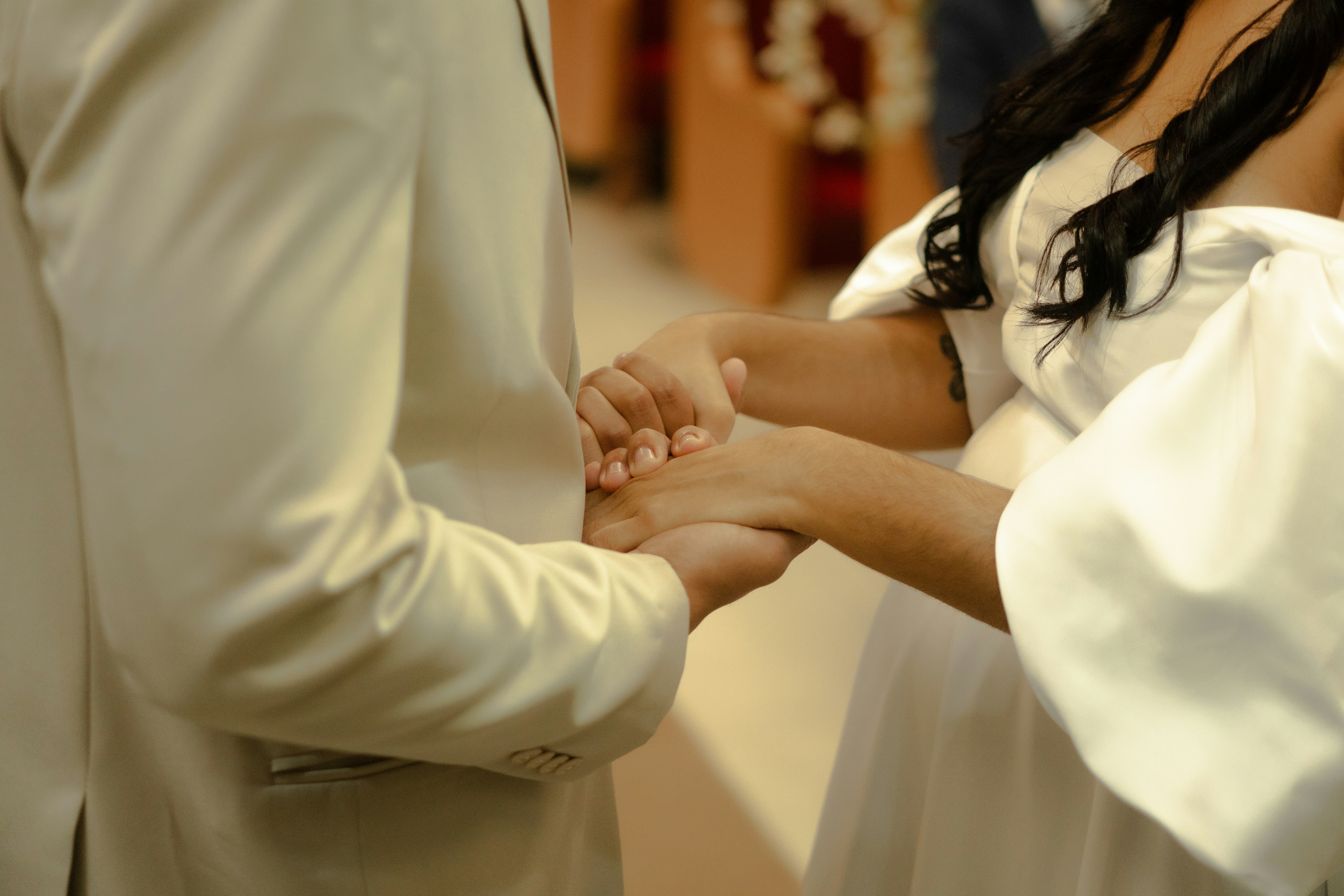 Couple holding hands during wedding ceremony