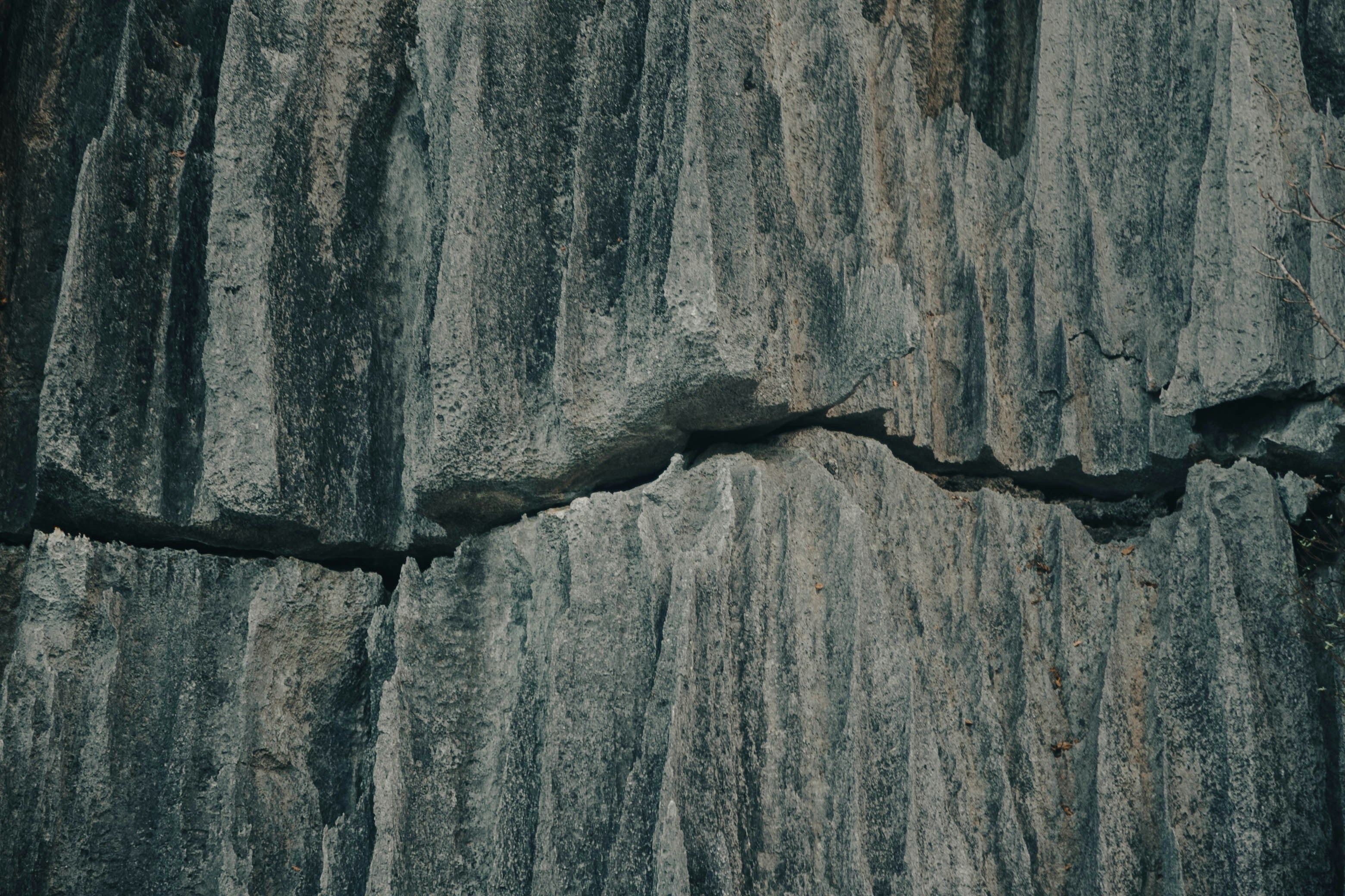 Close up of weathered grey rock with a crack.