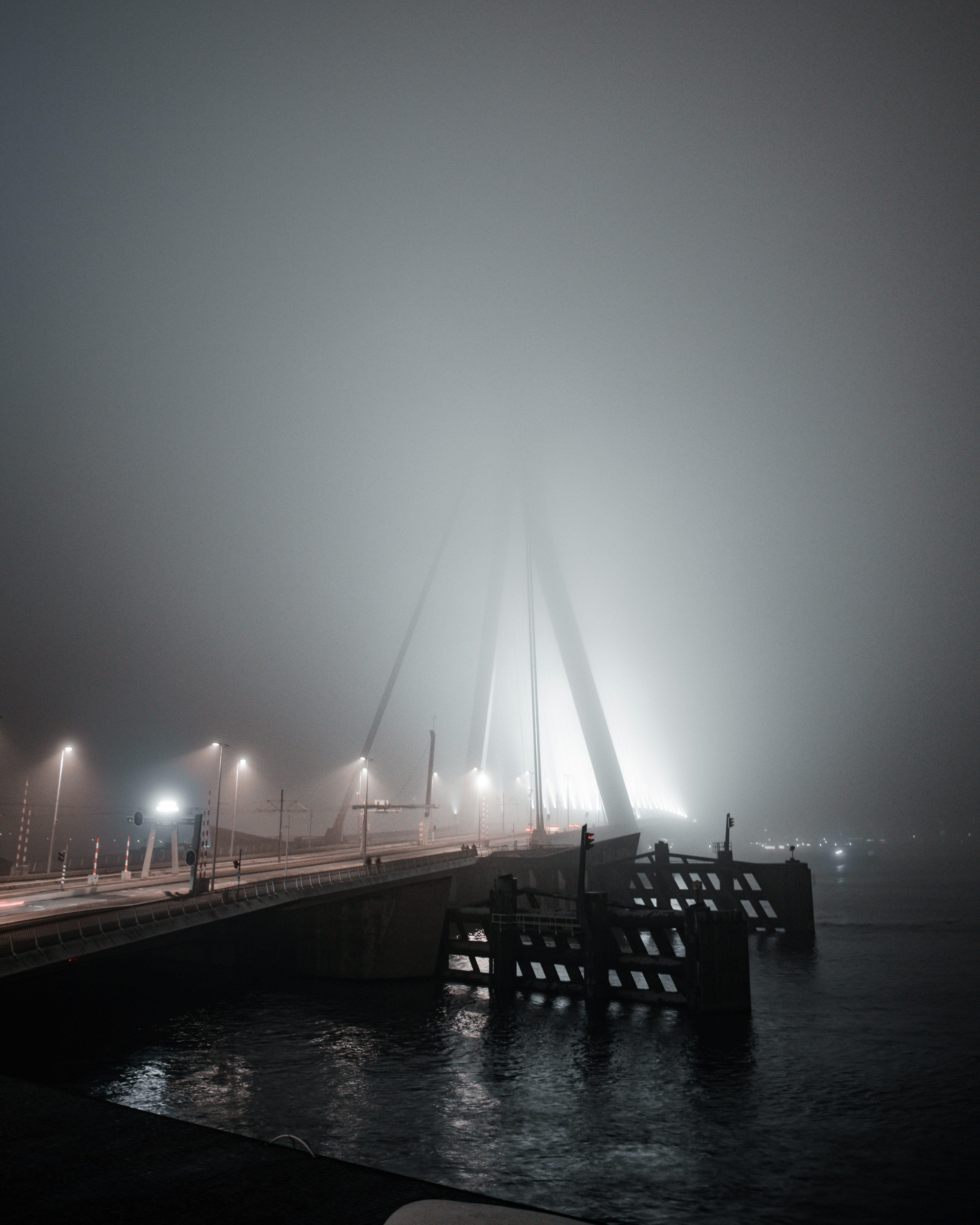 Bridge shrouded in thick fog at night