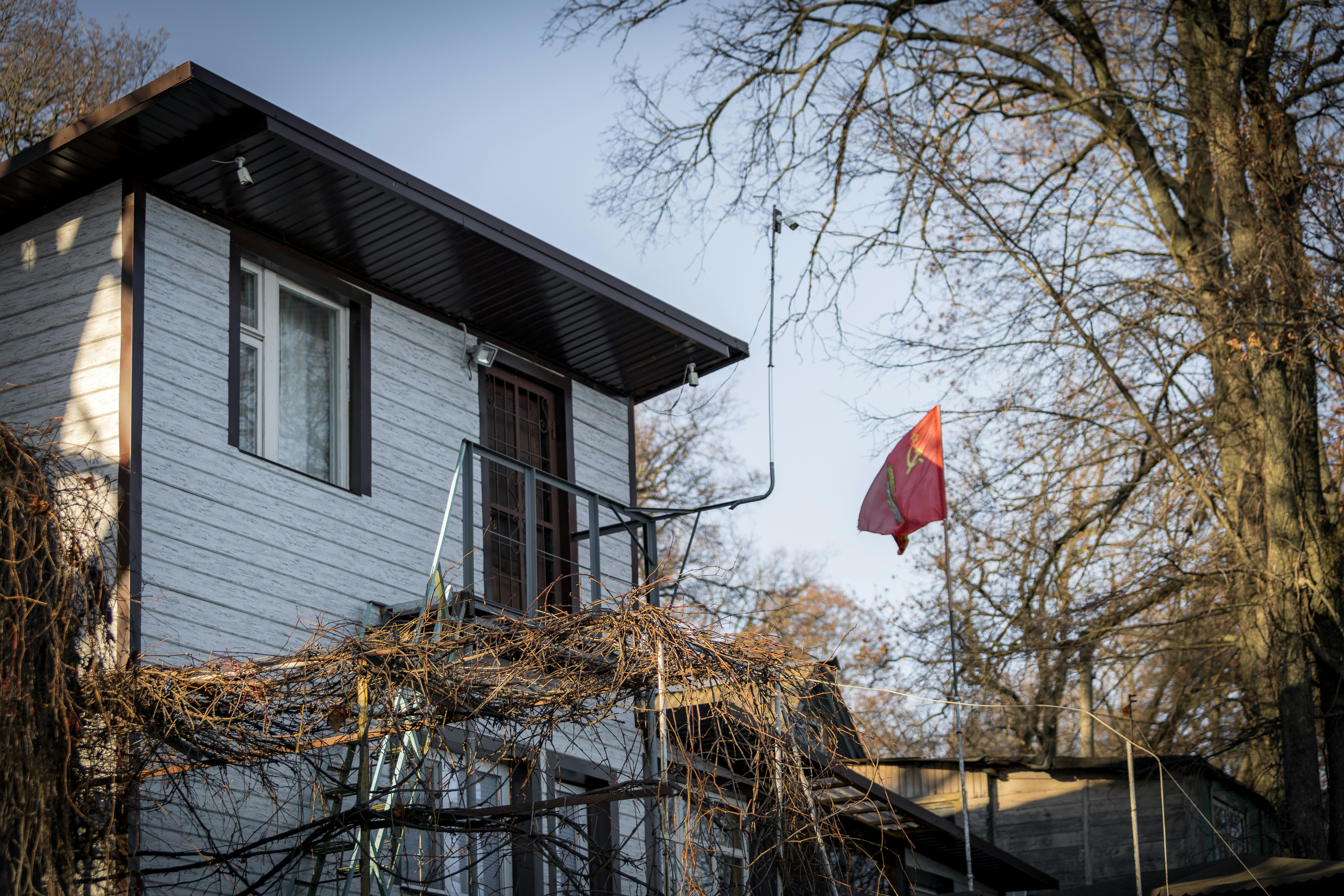 A house with a red flag flying