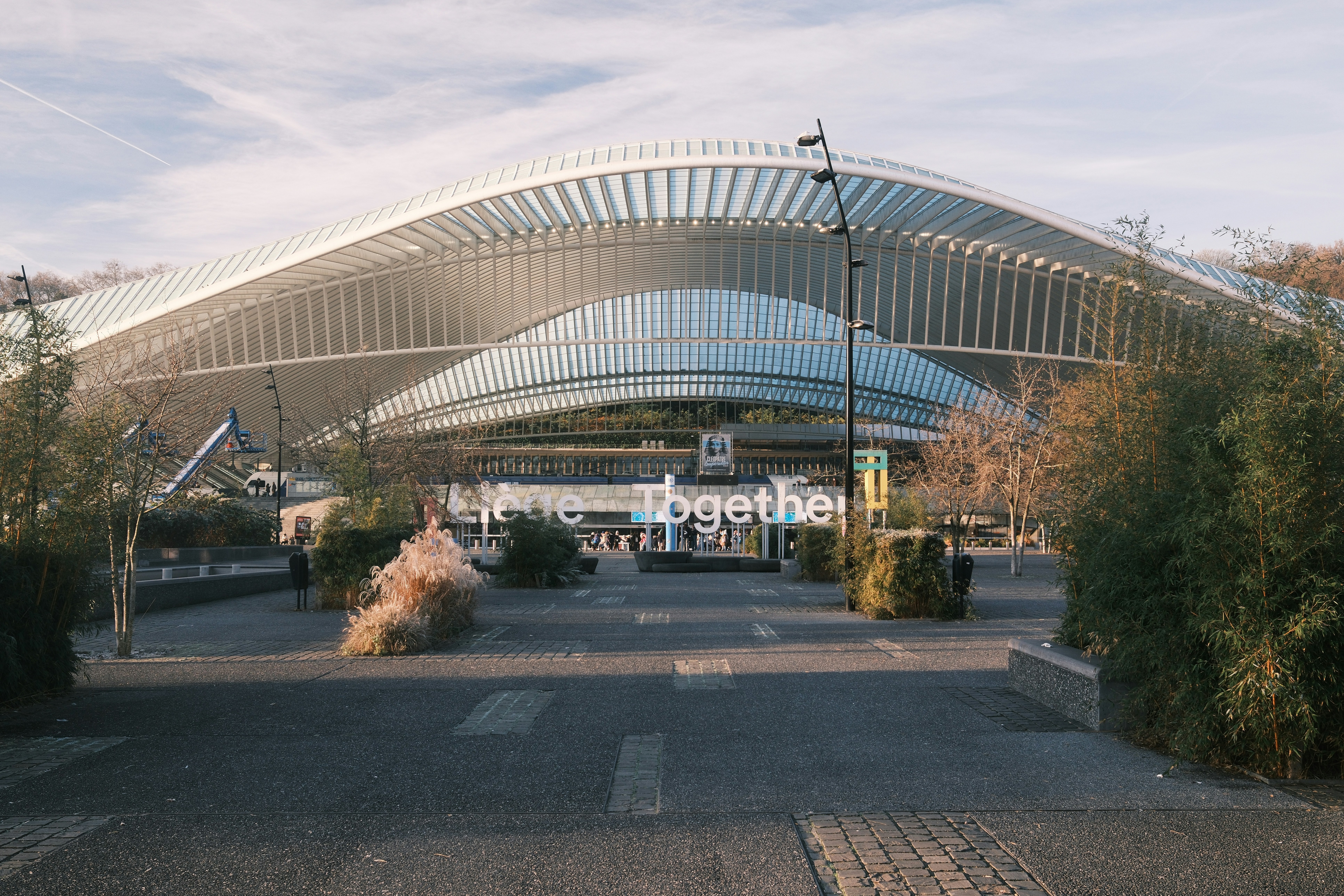 Modern train station with arched roof and signage.
