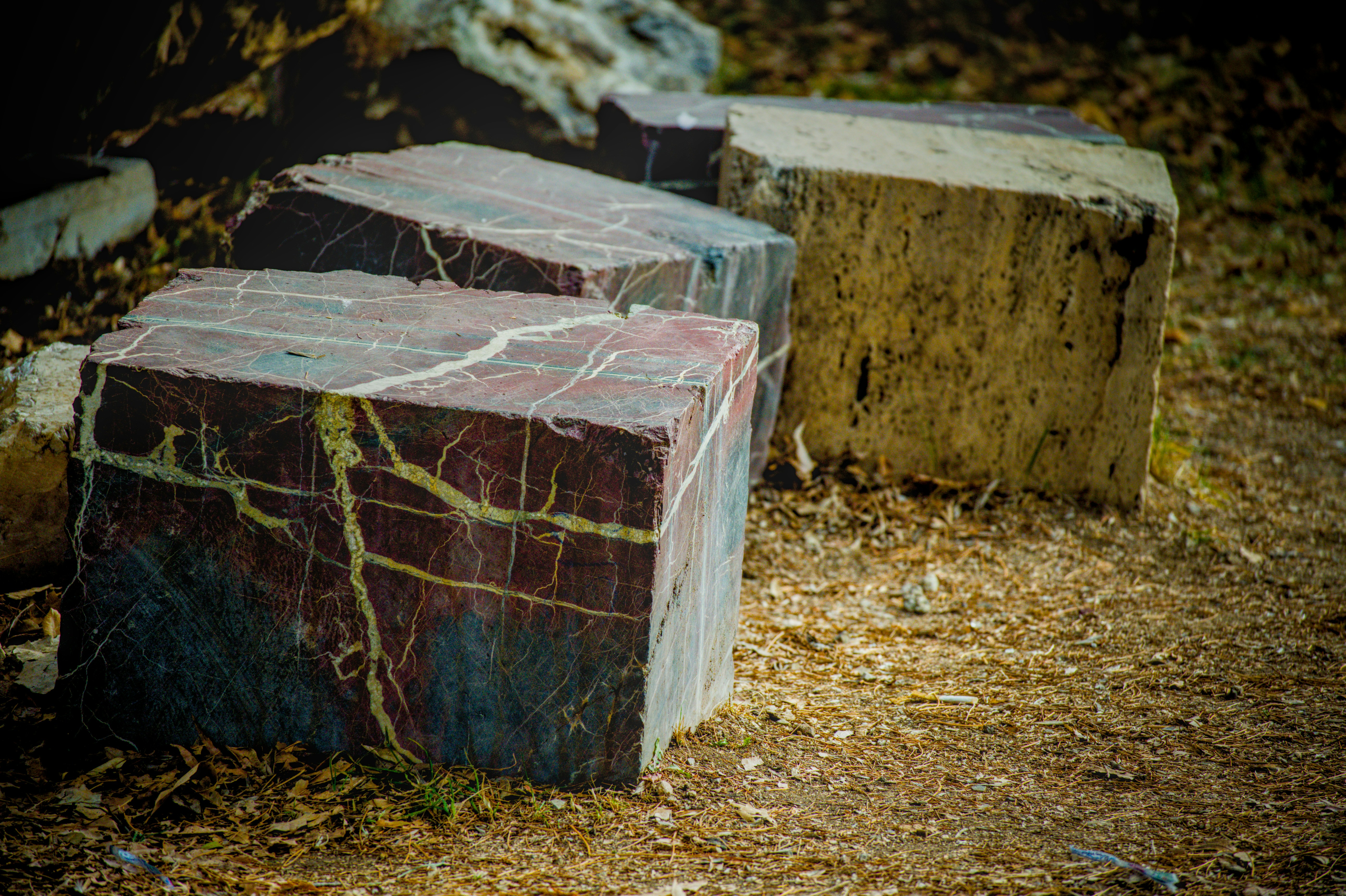 Cubic stones with colorful veins on the ground