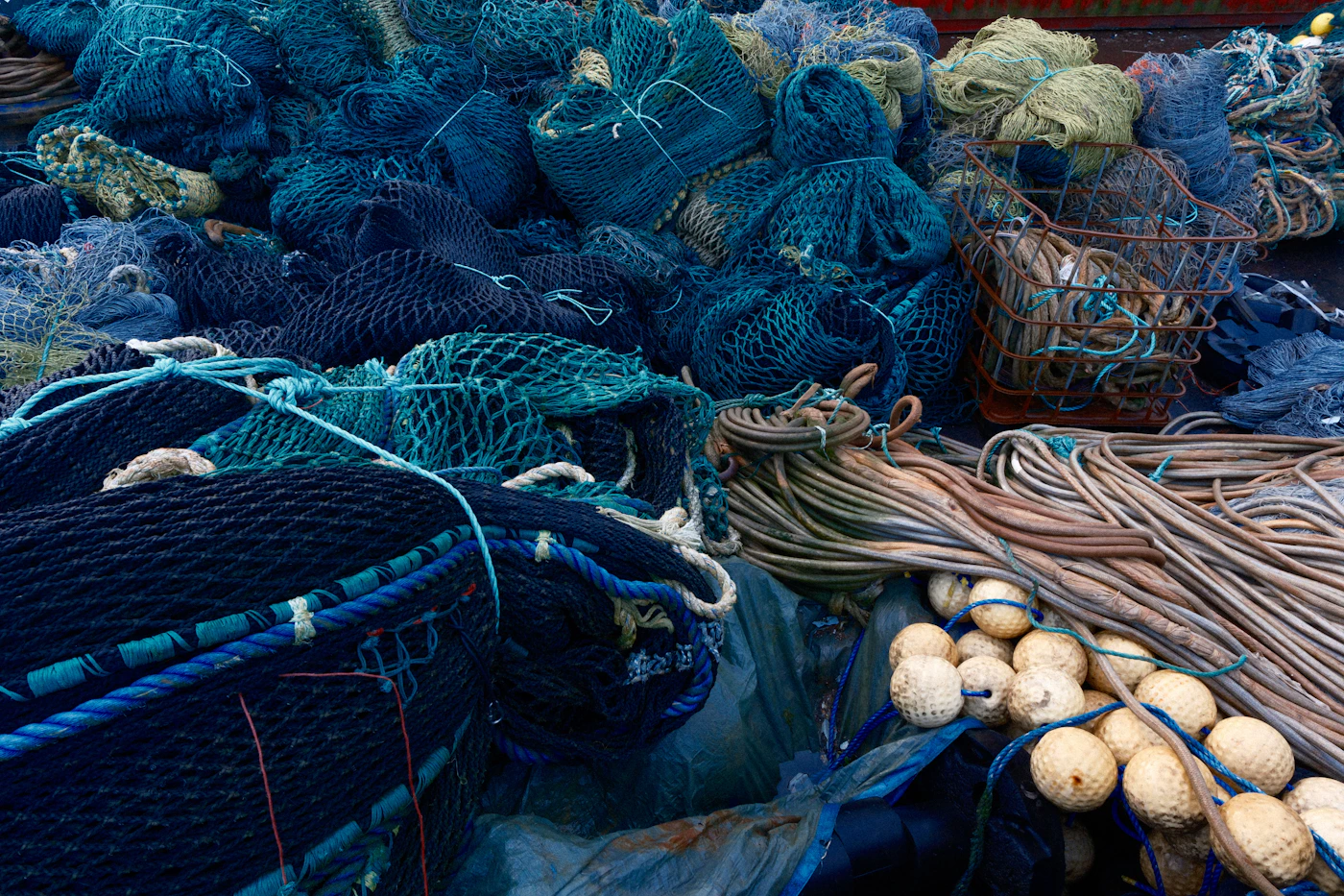 Pile of commercial fishing nets and buoys on a working vessel, gear used by crew who are covered as Jones Act seamen