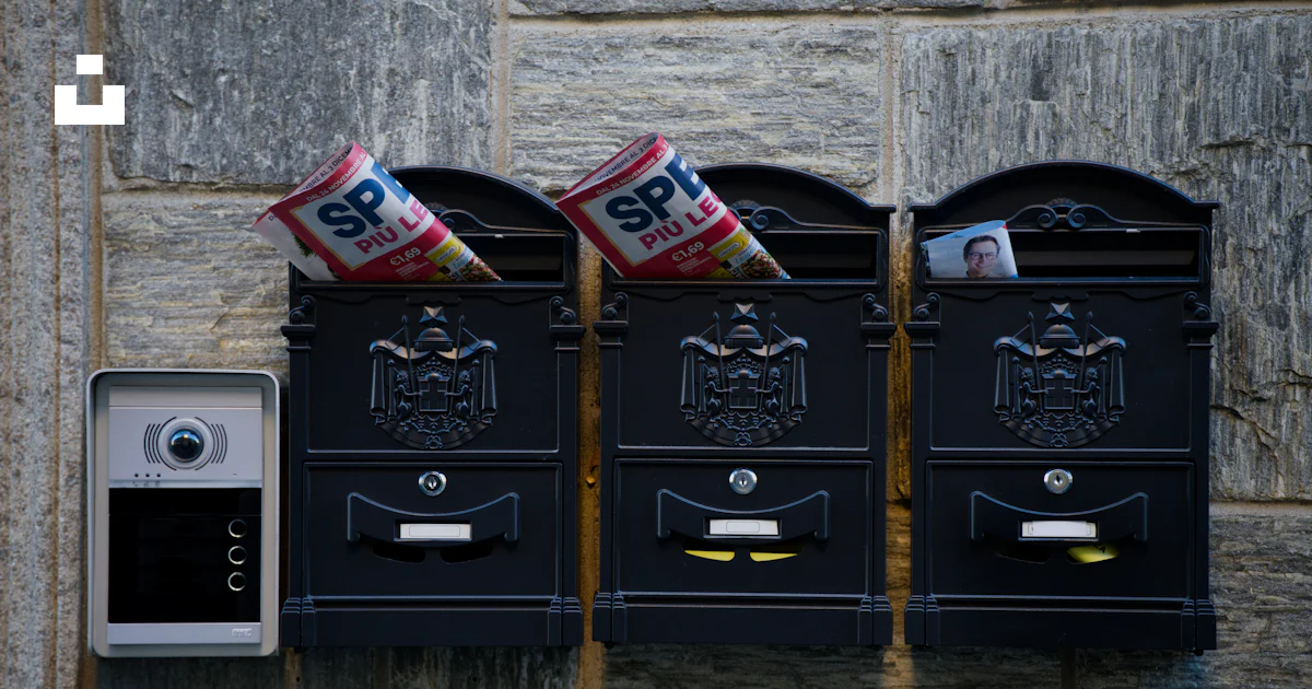 Three Mail Three mailboxes with mail and a doorbell. photo – Free Communication ...