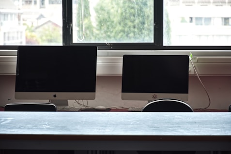 Two computer monitors on a desk