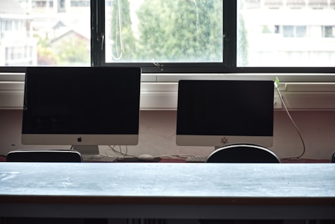Two computer monitors on a desk