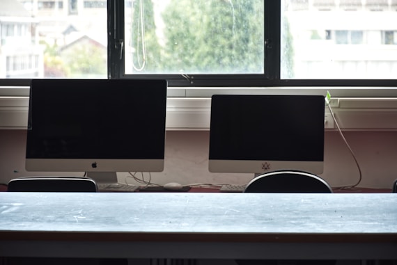 Two computer monitors on a desk