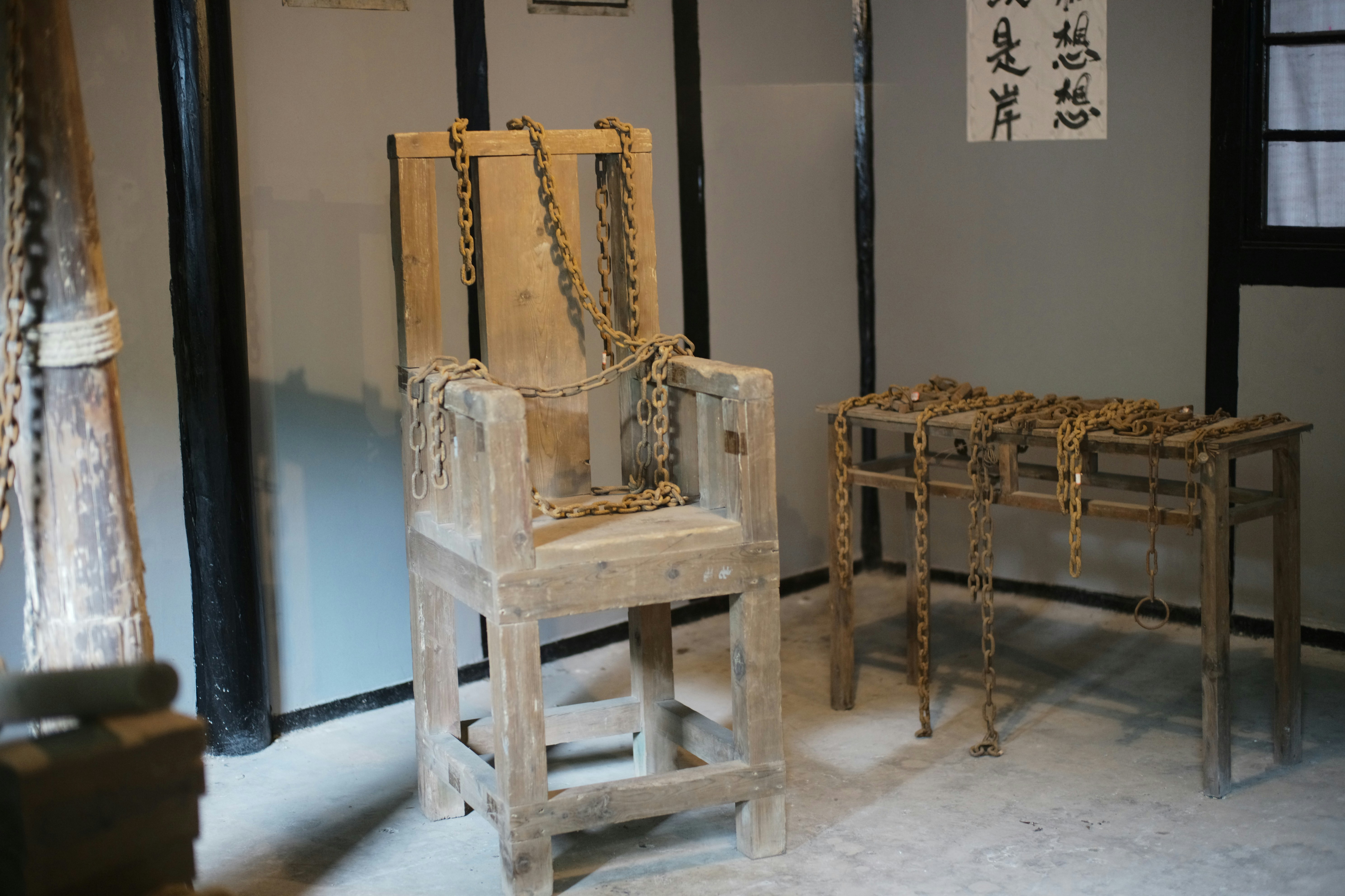 An antique wooden chair with chains