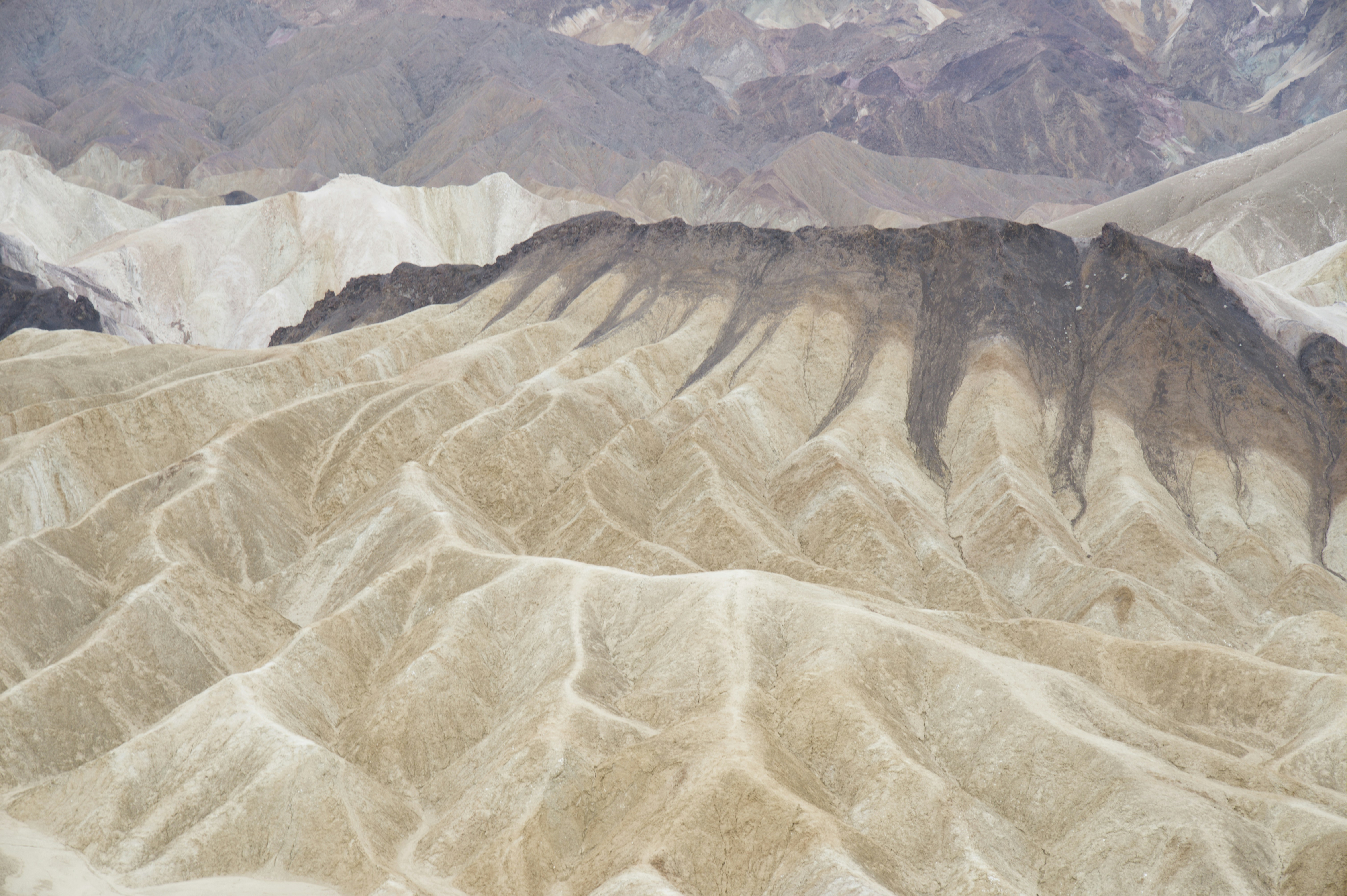 Barren desert hills with dramatic shadows and light