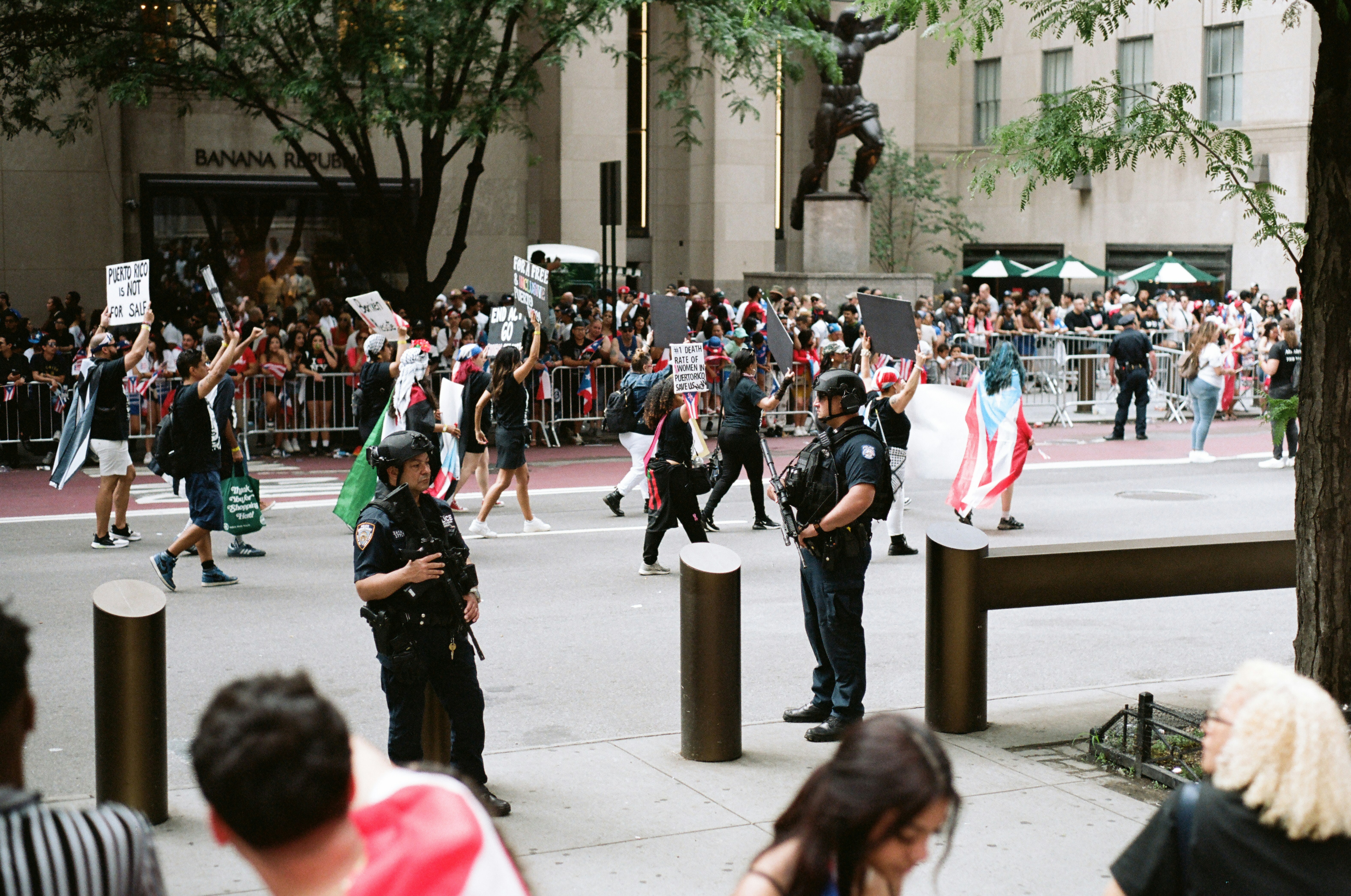 Protesters and police officers in a city street.