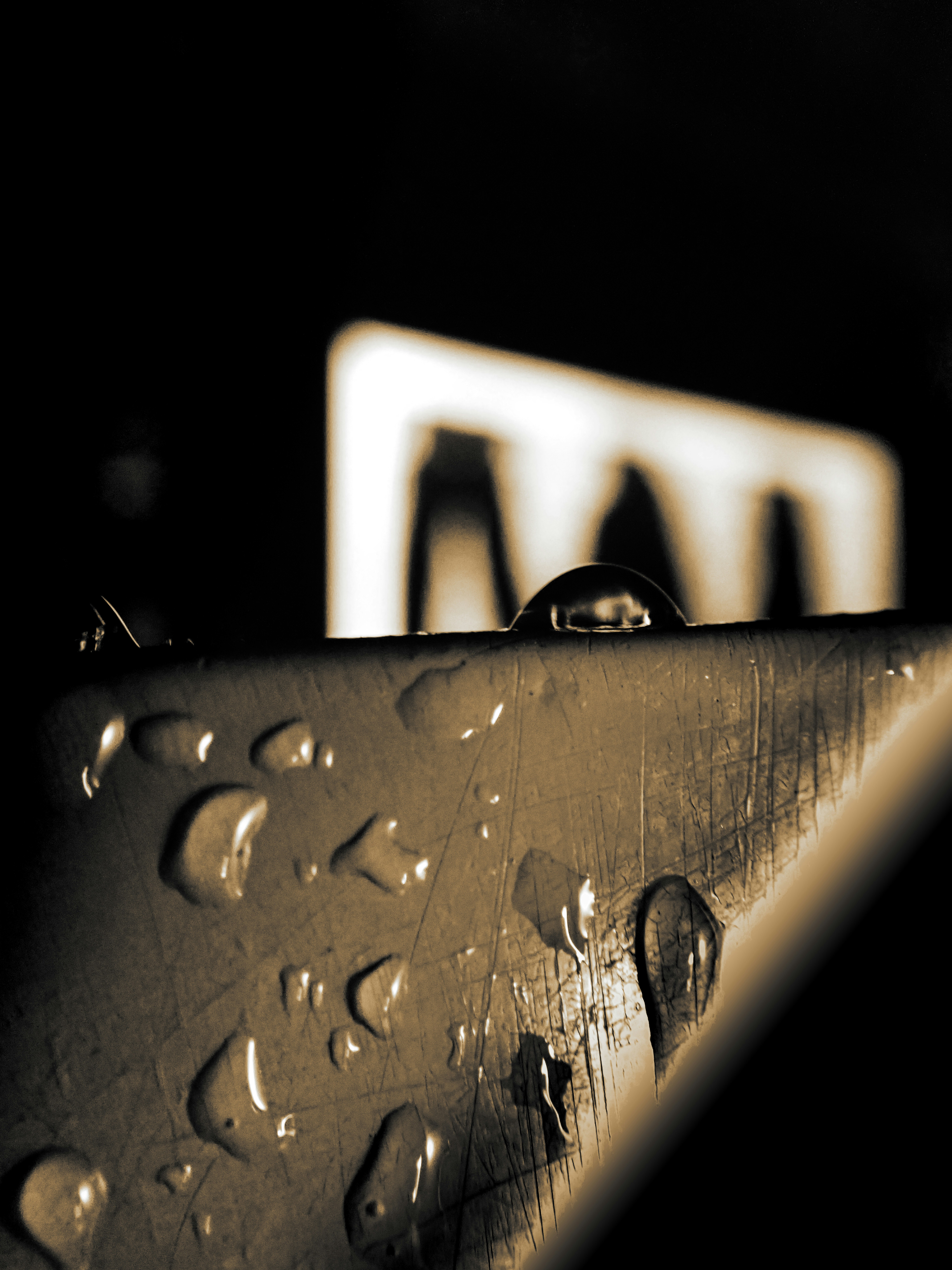 Water droplets on a textured surface with blurred background