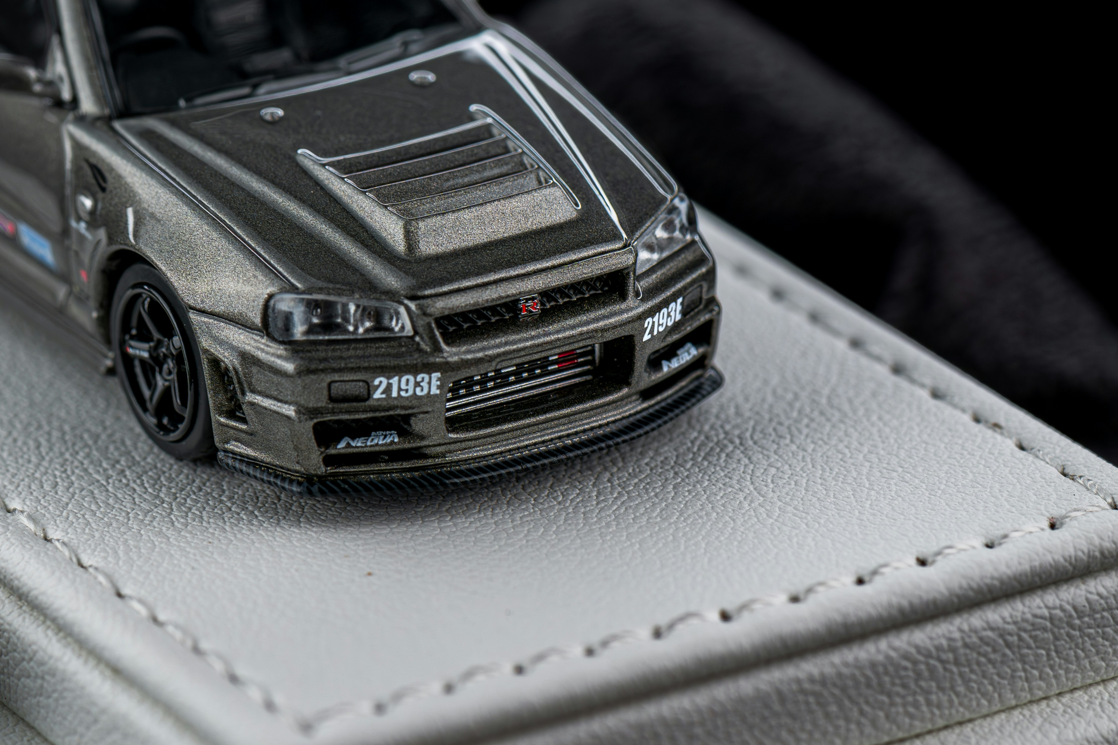 A fully detailed car gleaming under bright lights.