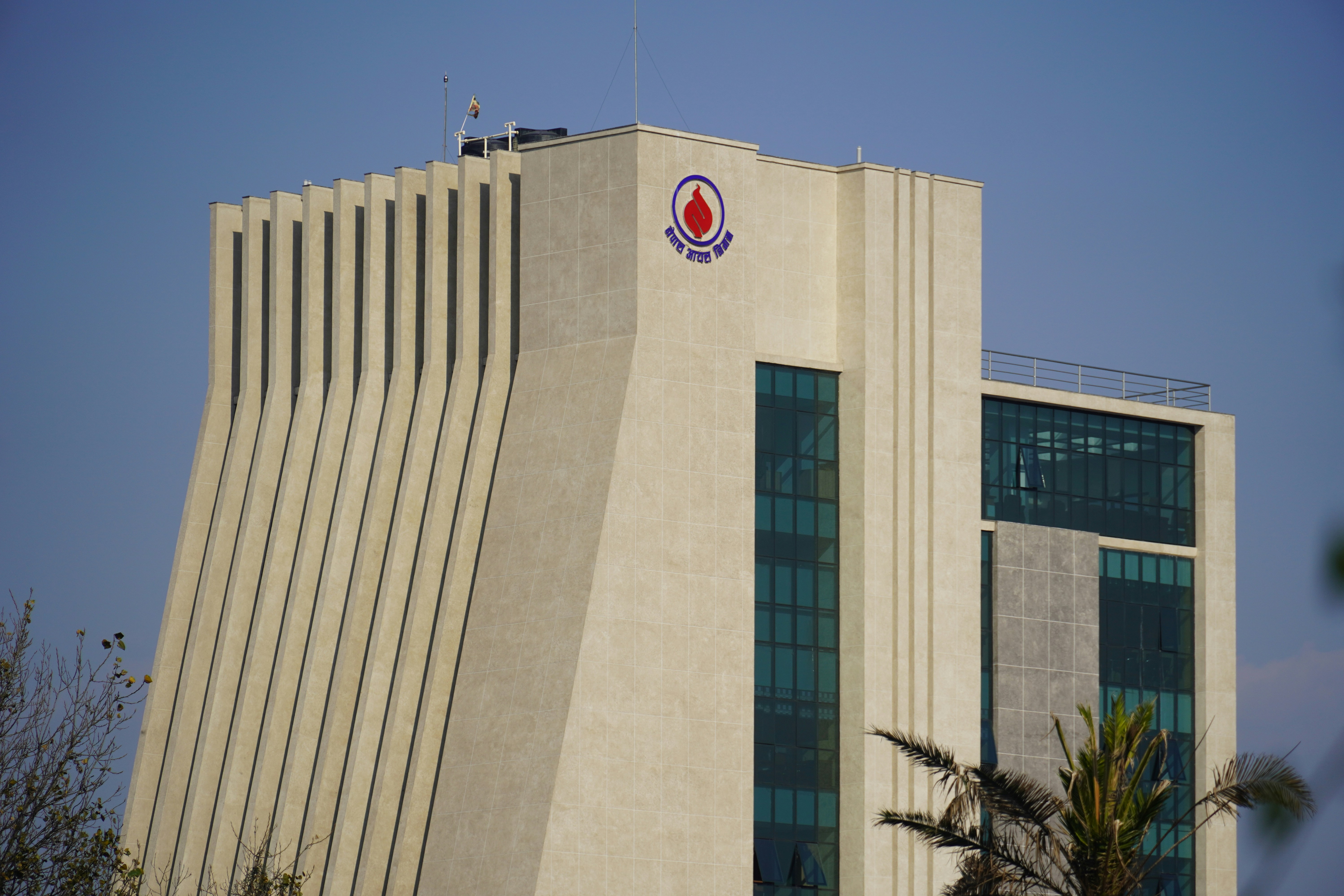 Modern building with a logo against blue sky