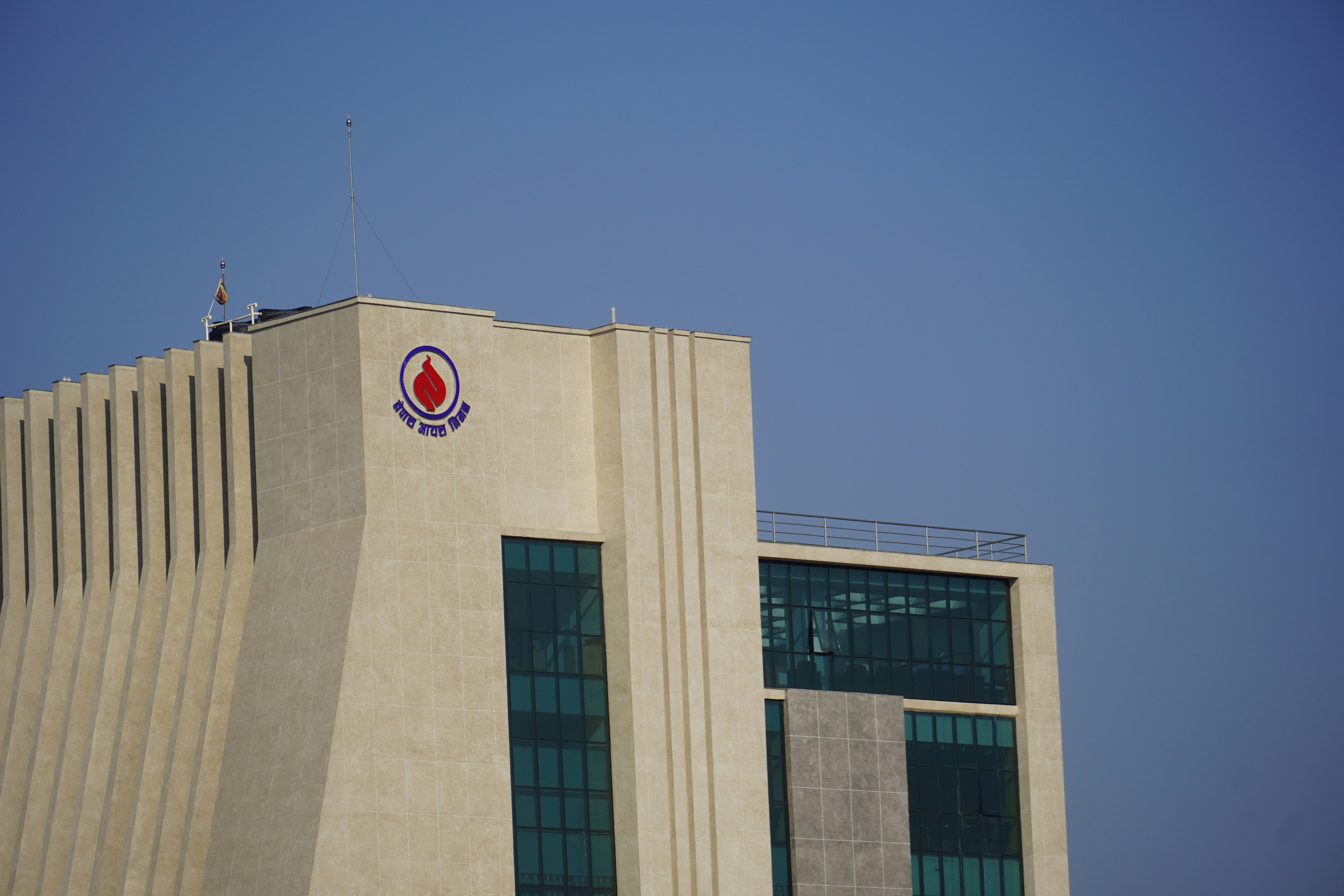 Modern building with a logo against clear sky