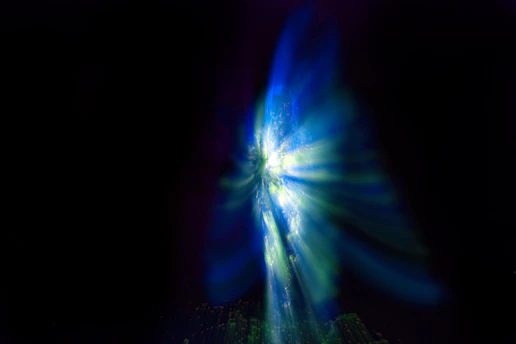 Abstract blue and white light burst against black