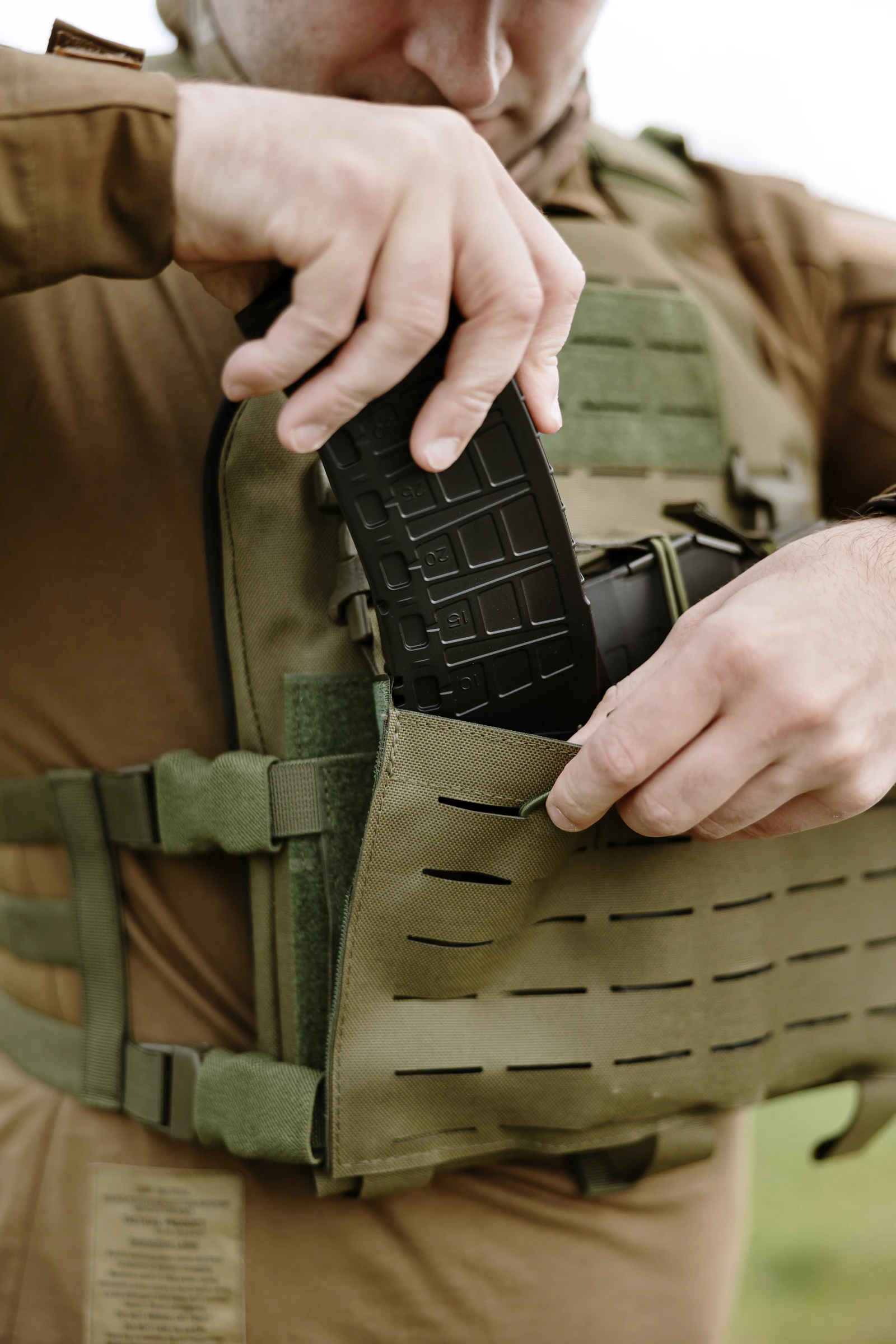 Tactical athlete in a plate carrier with range equipment during performance training